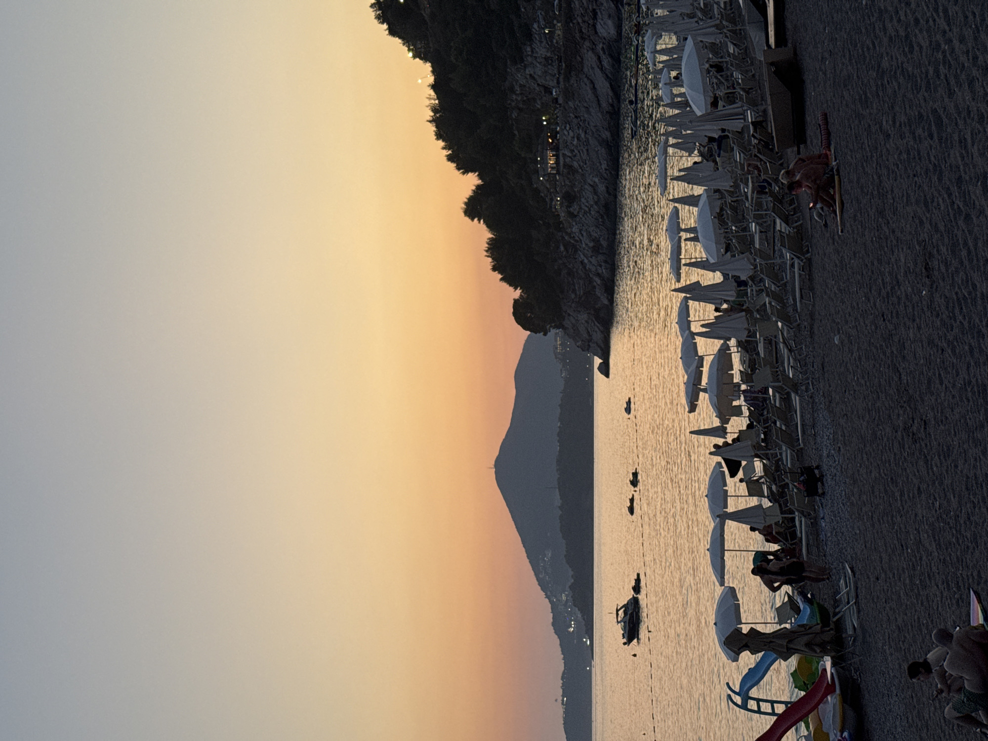 Sunset over Kamenovo Bay with parasailing activity