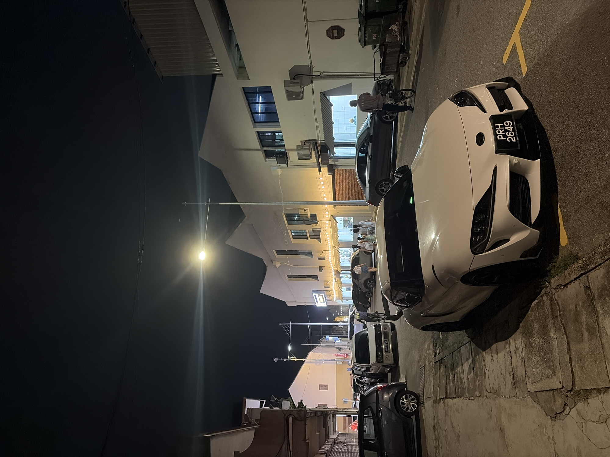 White Toyota Supra parked on a city street at night