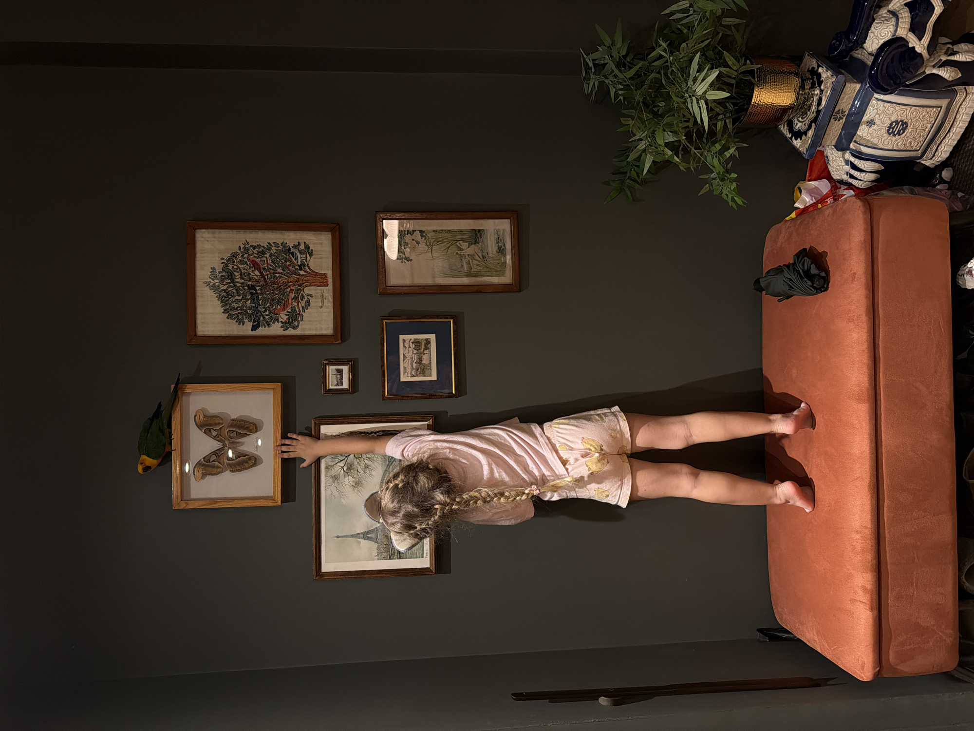 Reaching up to touch wall art in a Khimki apartment
