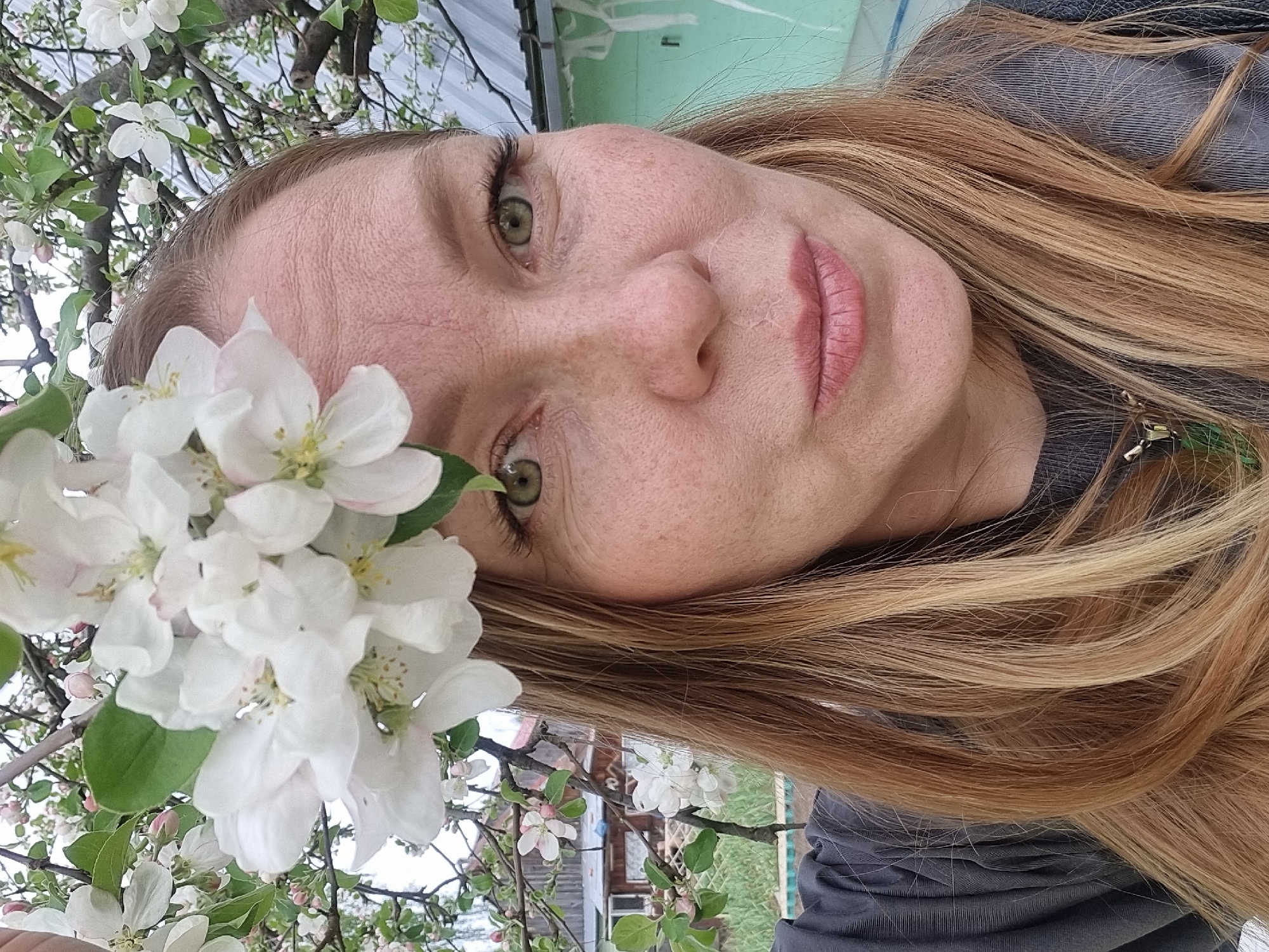 Woman photographs spring blossoms in Chaikovsky, Russia