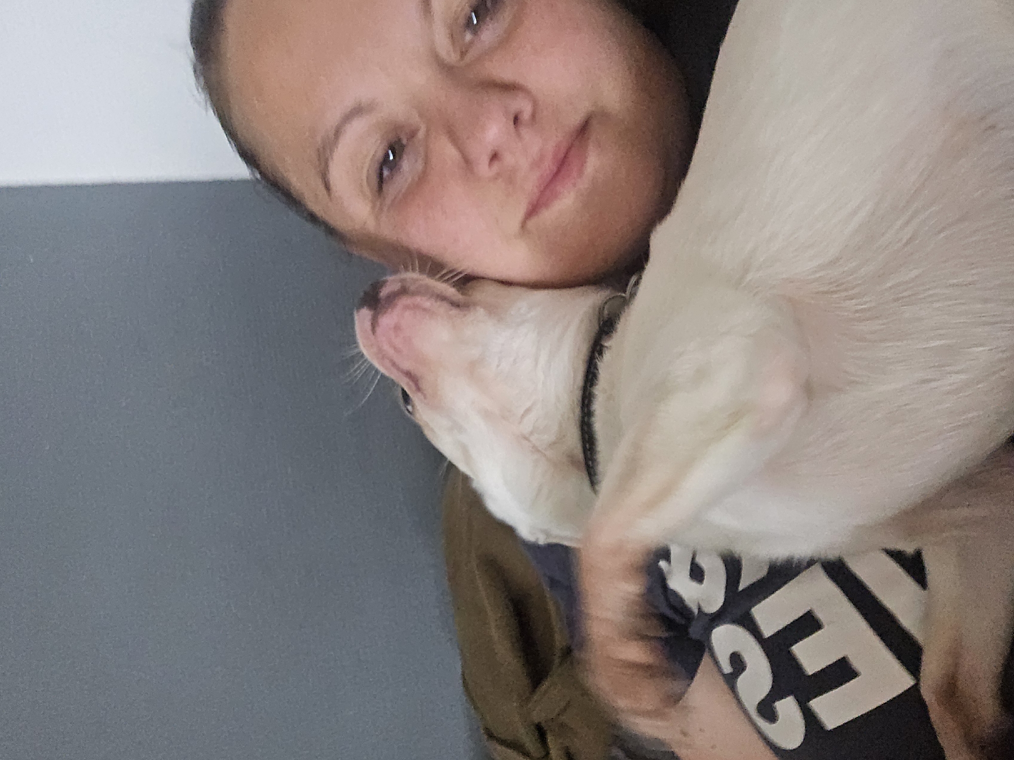 Woman photographed with small dog in Hem, France