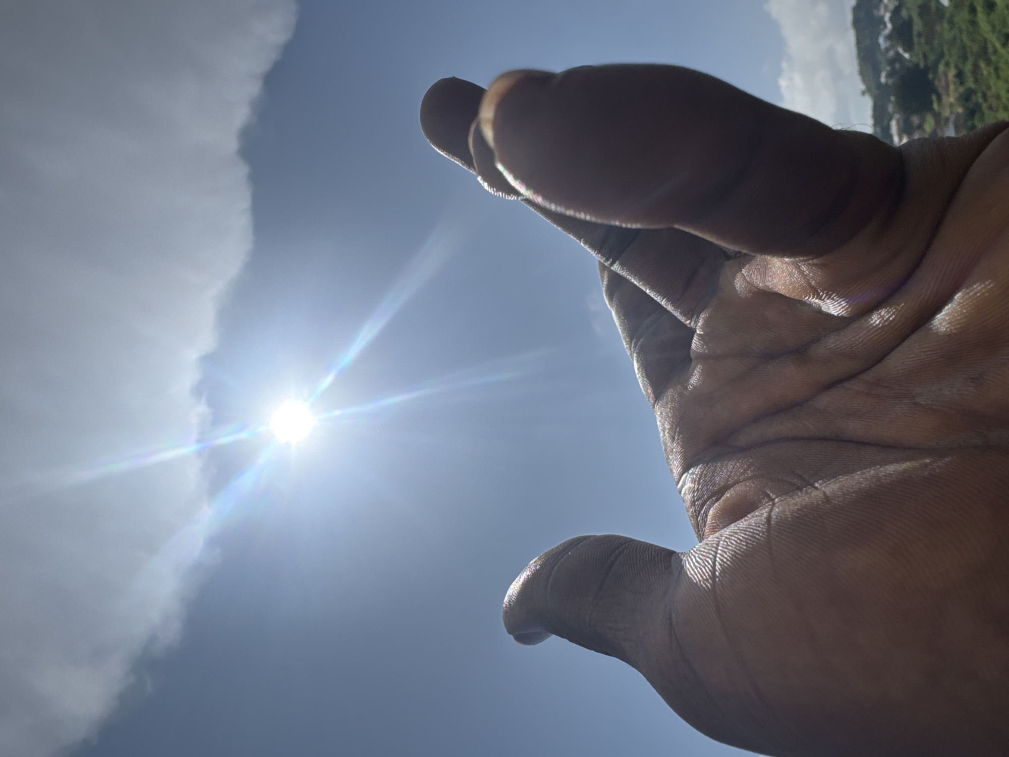 Hand reaching toward the sun, multiple angles on a bright sky