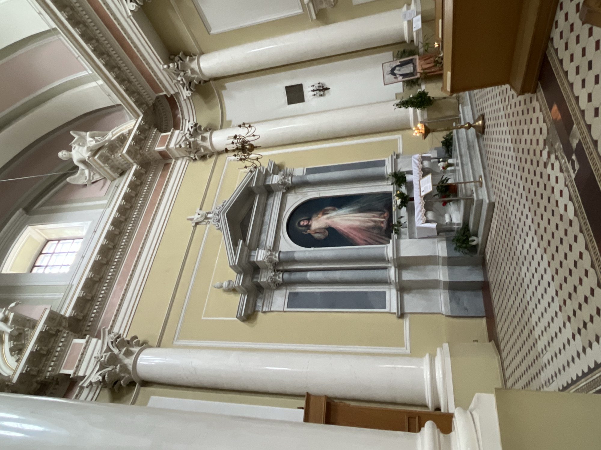 Visitor documents ornate church interior and religious artwork in Saint Petersburg