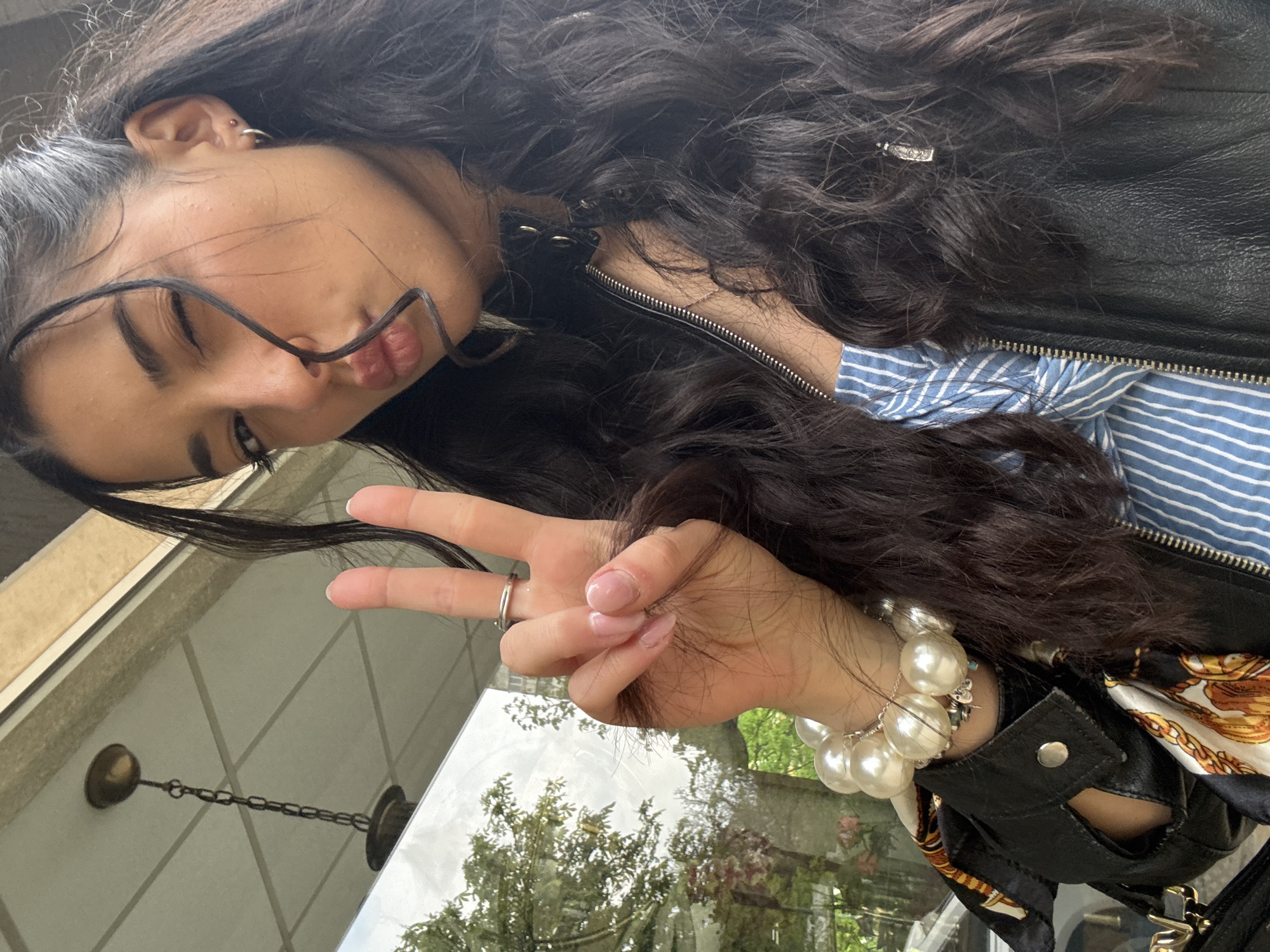 Woman takes playful selfies on Sofia street