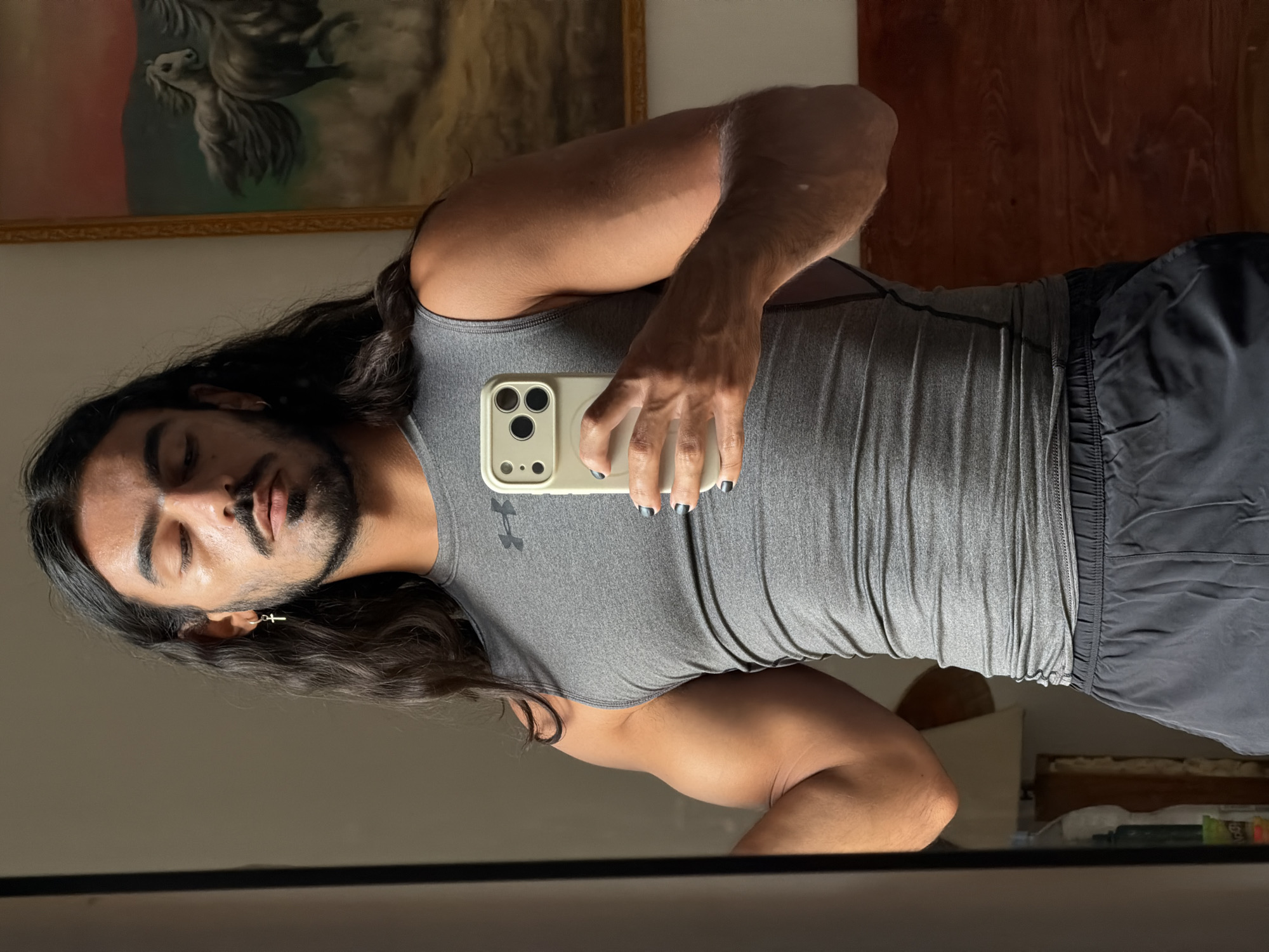 Man Takes Multiple Mirror Selfies in North Kuta Room