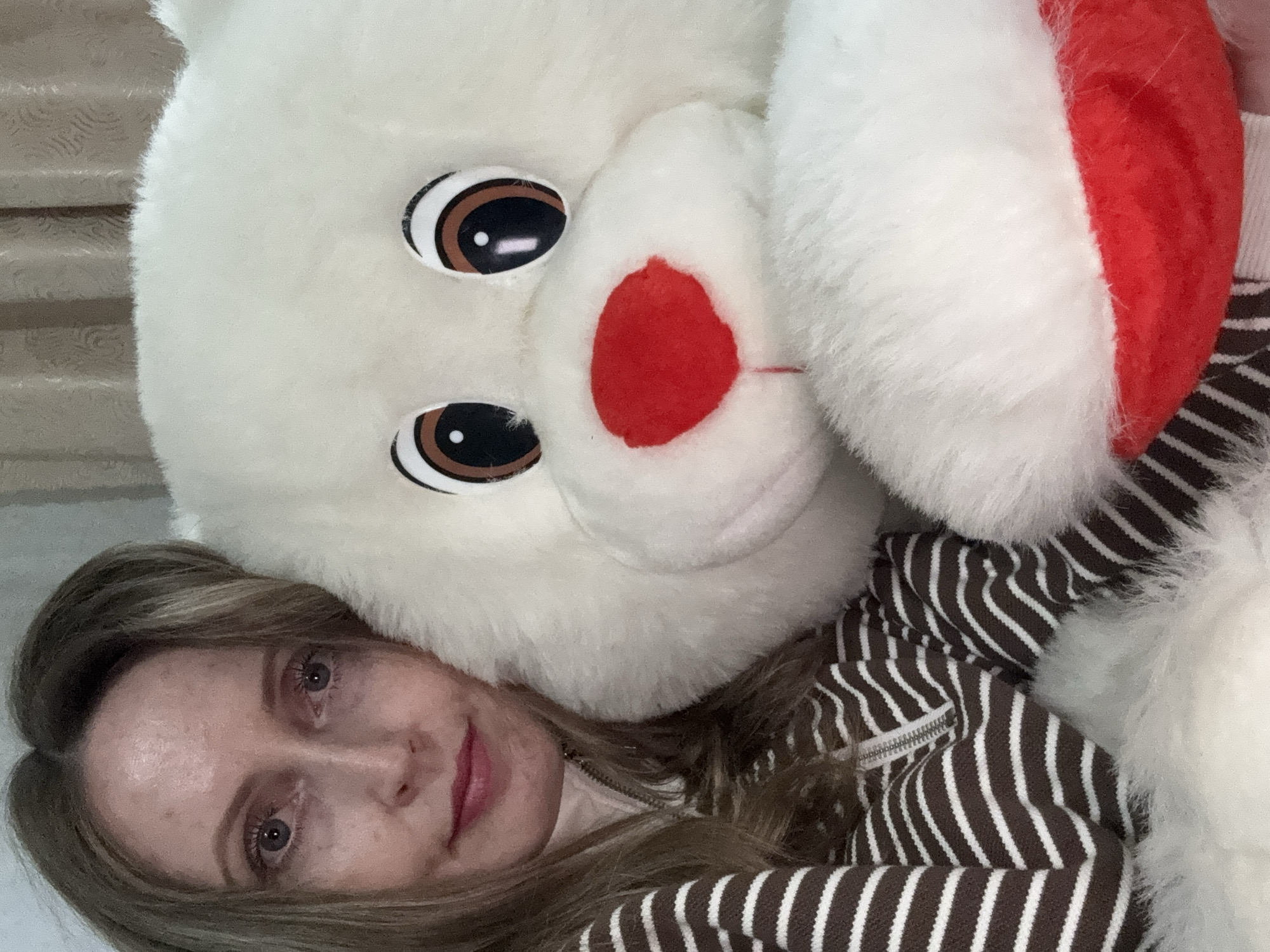 Woman takes selfies with plush toy and peonies in Russia