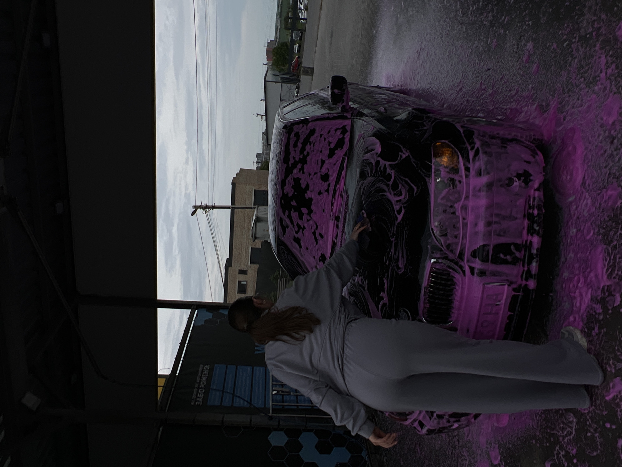 Woman washes BMW with pink foam at Ukrainian car wash