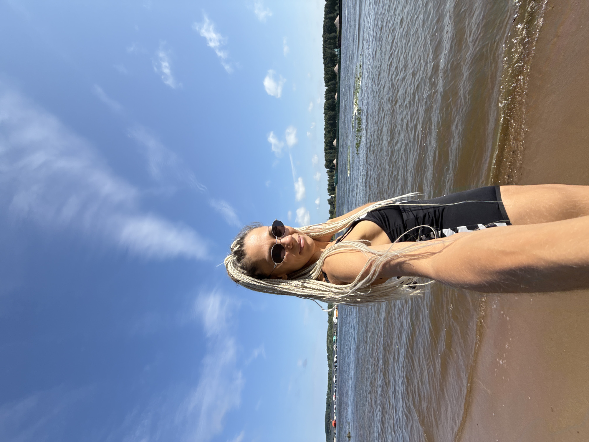 Beach day on the Volga with river cargo traffic passing by