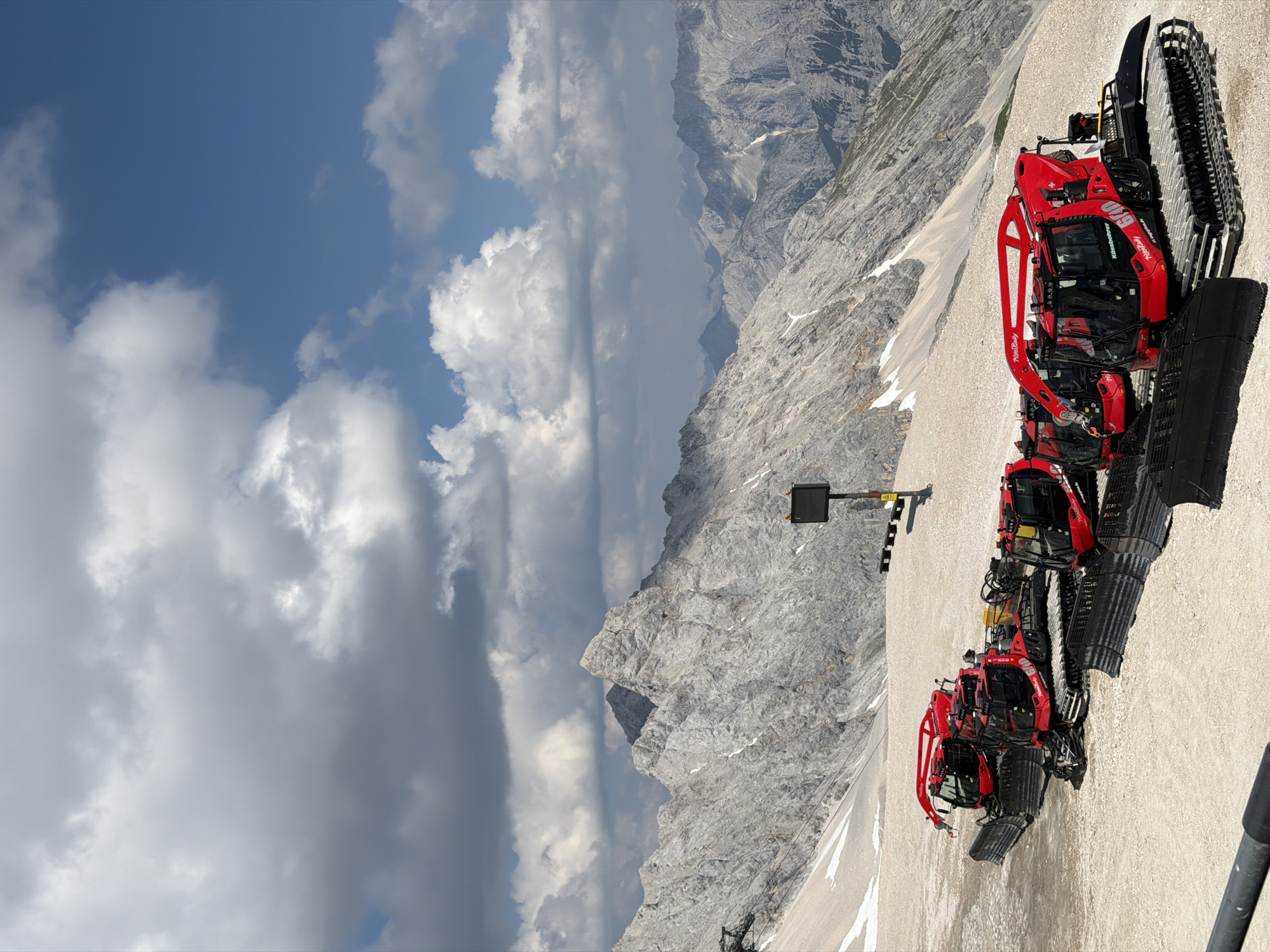 Snow groomers parked high on a Bavarian Alpine slope