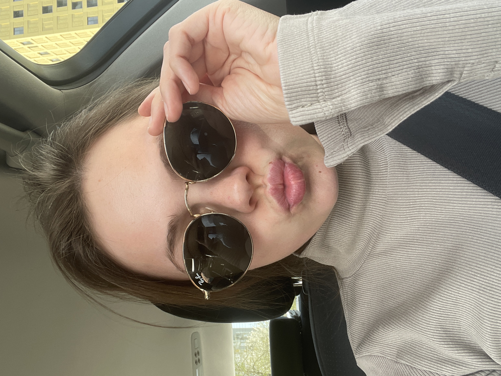 Woman takes car selfies with sunglasses in Ljubljana