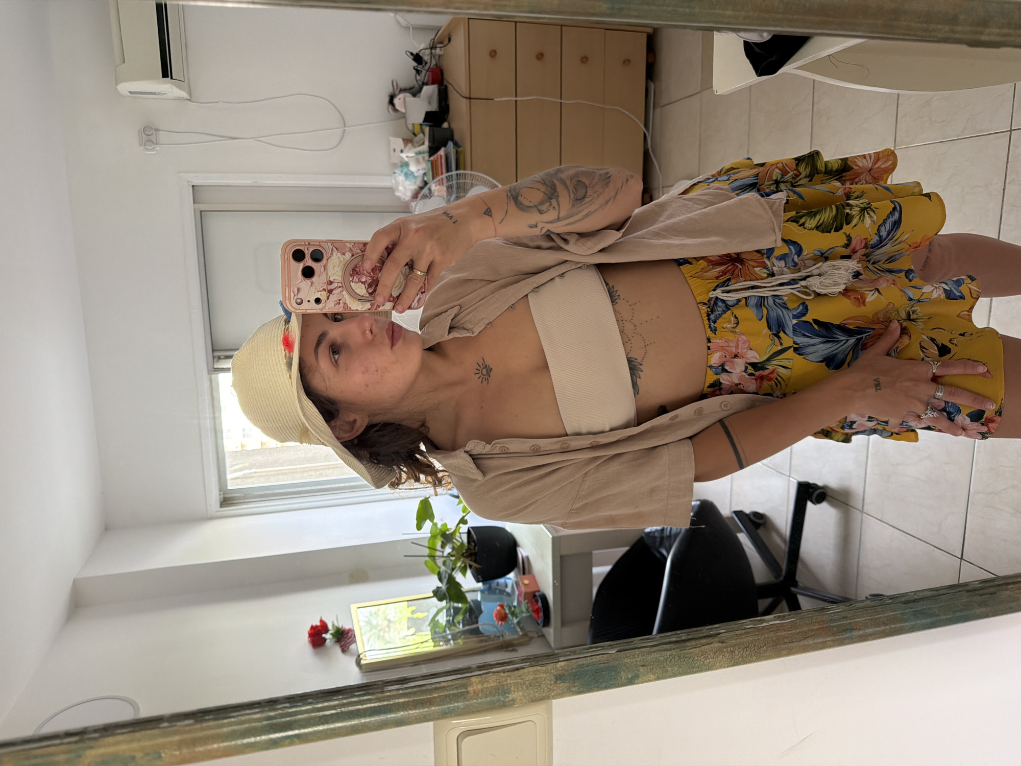 Woman takes mirror selfie in Kiryat Bialik wearing summer outfit
