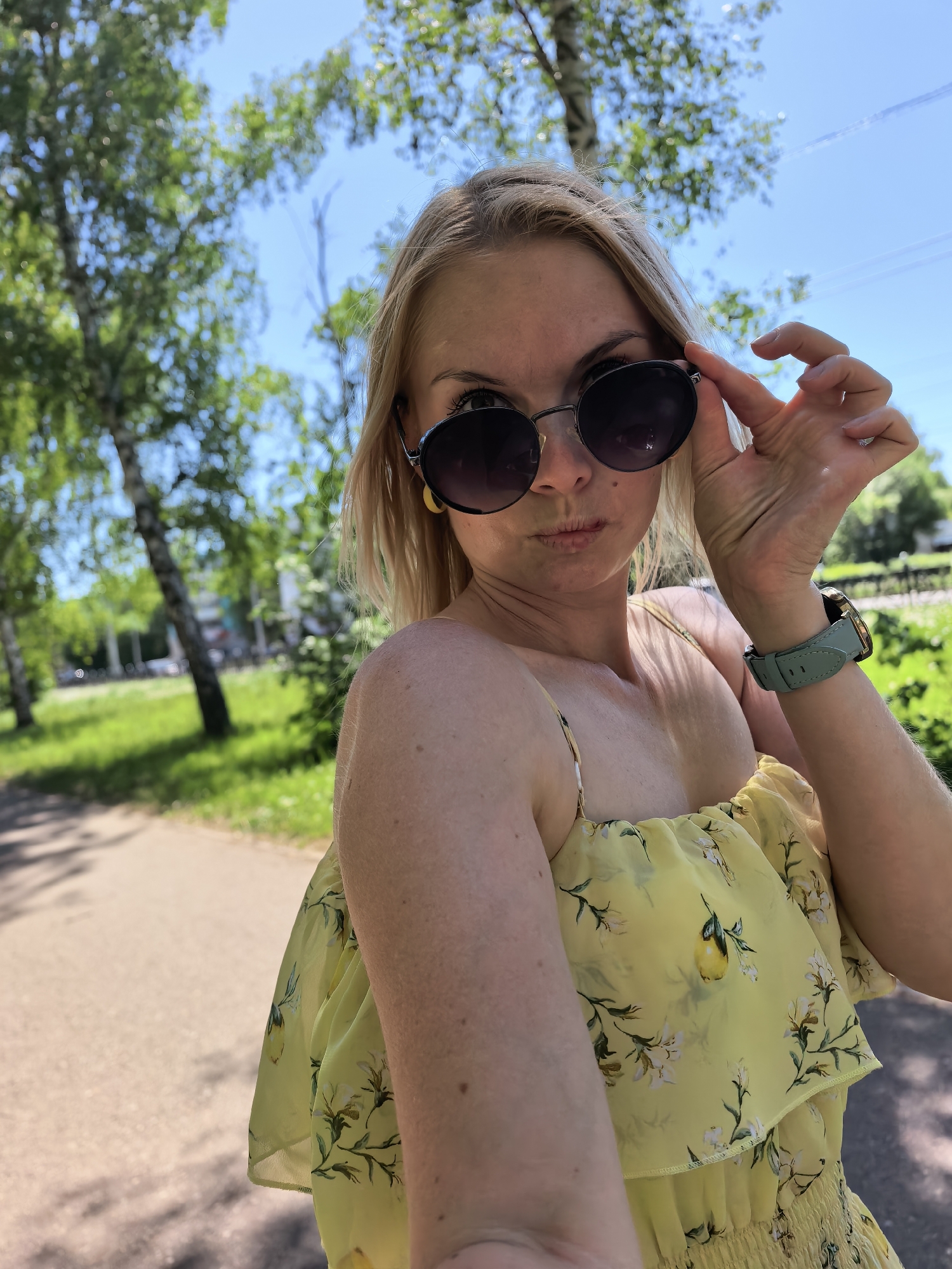 Woman photographs selfies with flowers in Sterlitamak morning session
