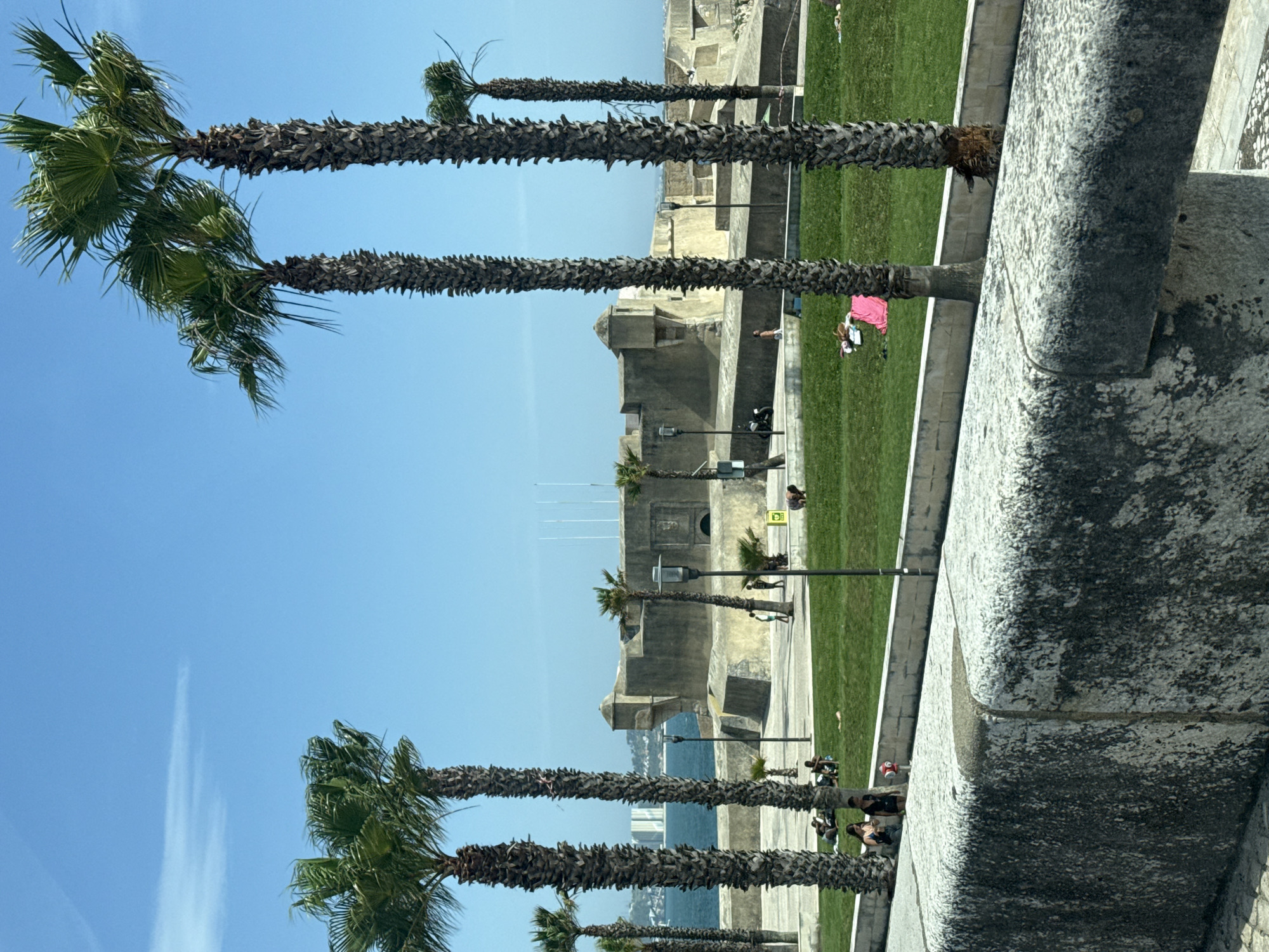 Coastal drive through Oeiras with beach and fortress views
