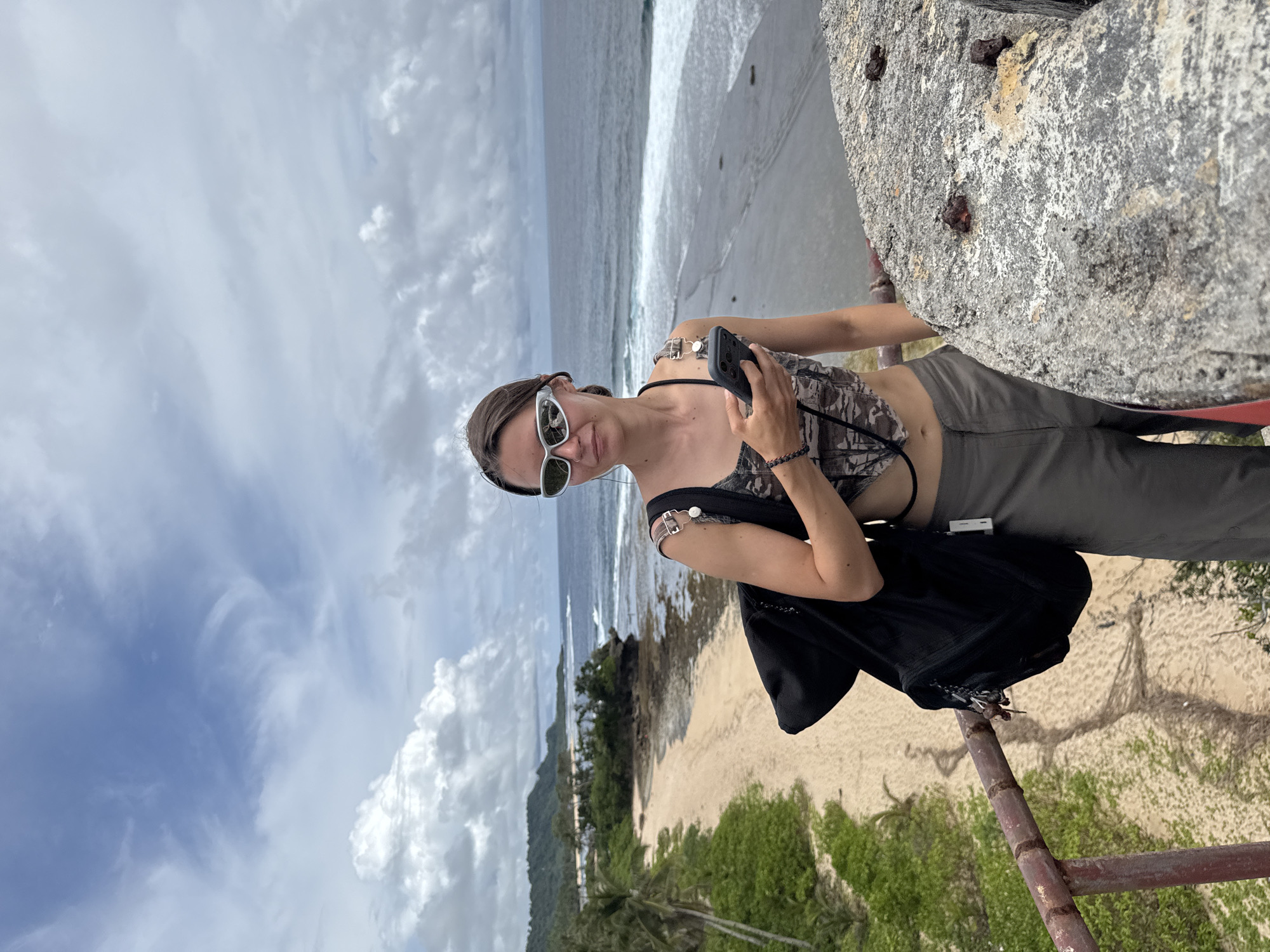 Tourist documents coastal scenery in San Isidro, Philippines
