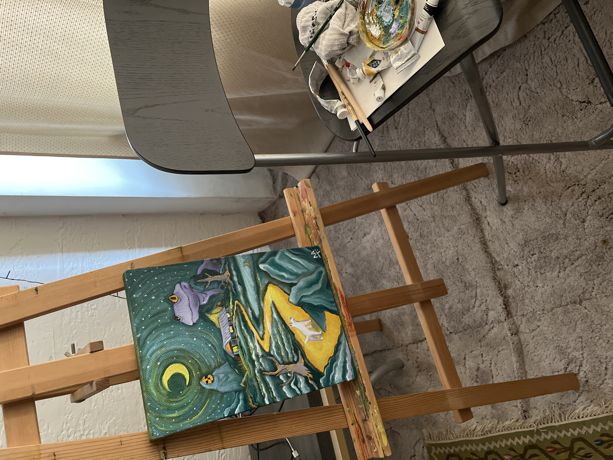 Artist workspace captures mystical landscape painting with glowing elements