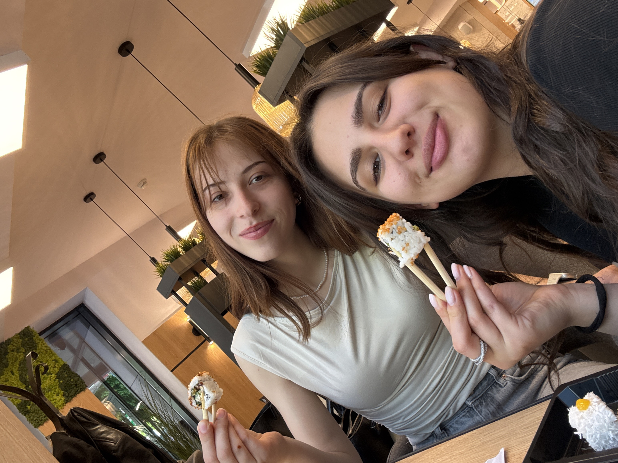 Two women share sushi meal in Sofia indoor venue