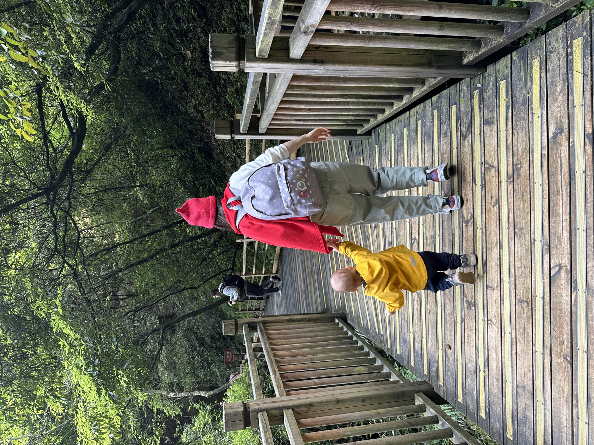 Tourists explore wooden walkways and caves in Zhangjiajie, China