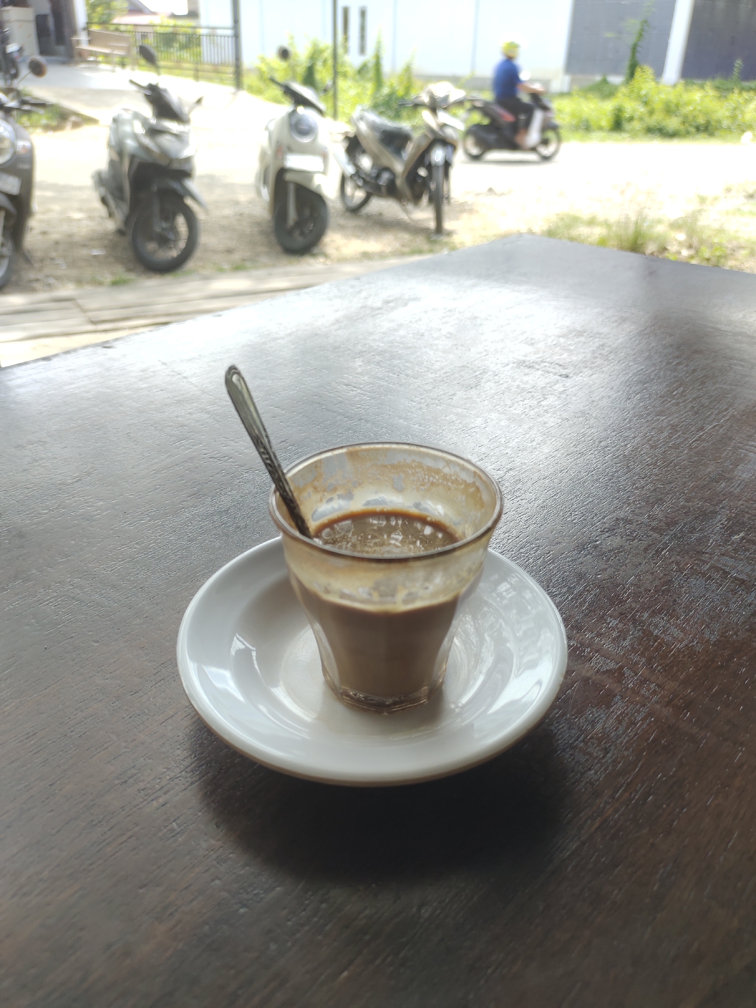 Early morning coffee stop near a clothing shop in Keudematangkuli