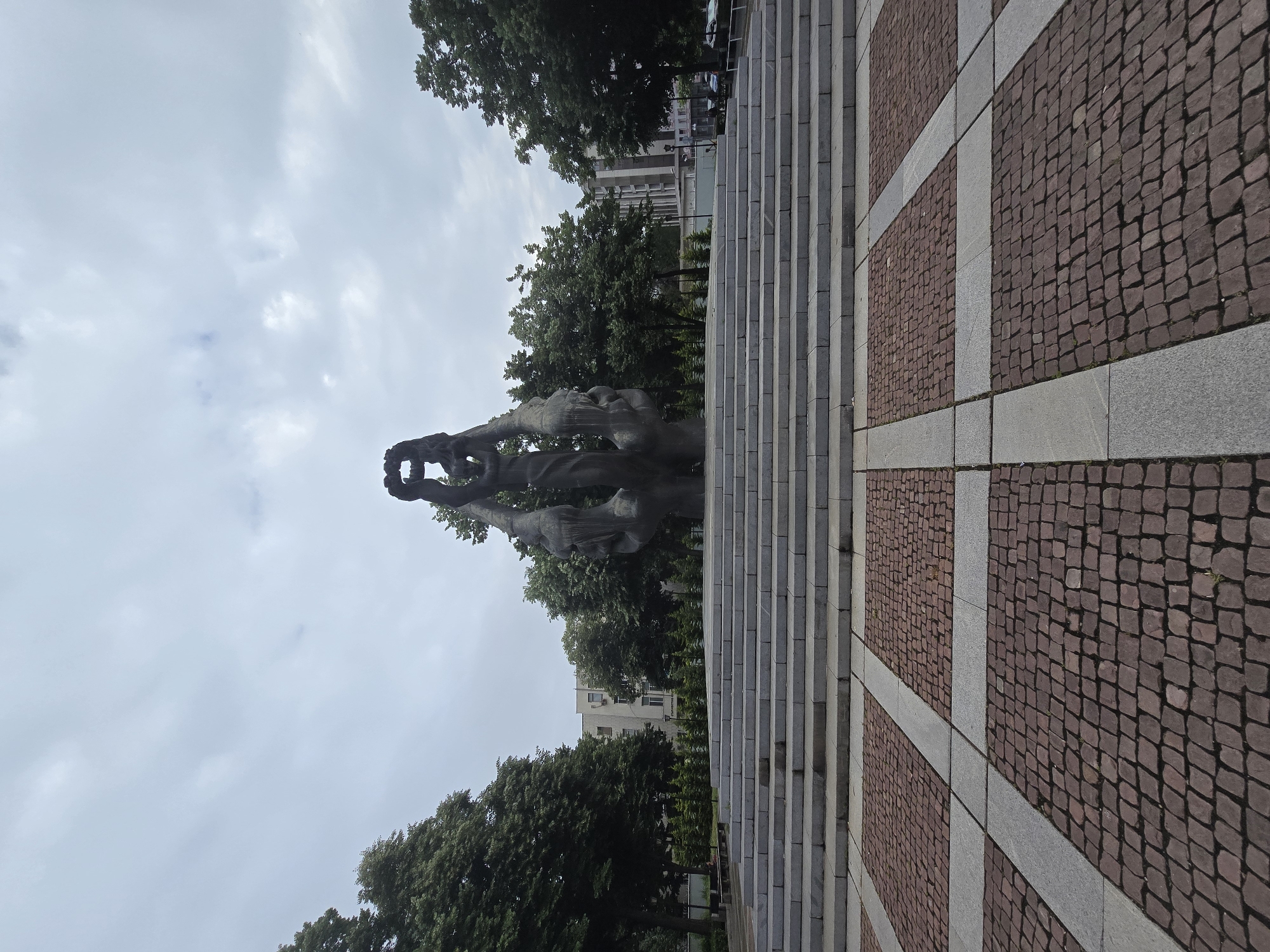 Art viewing session captured: outdoor monument, door grid, wall frames, macaw print
