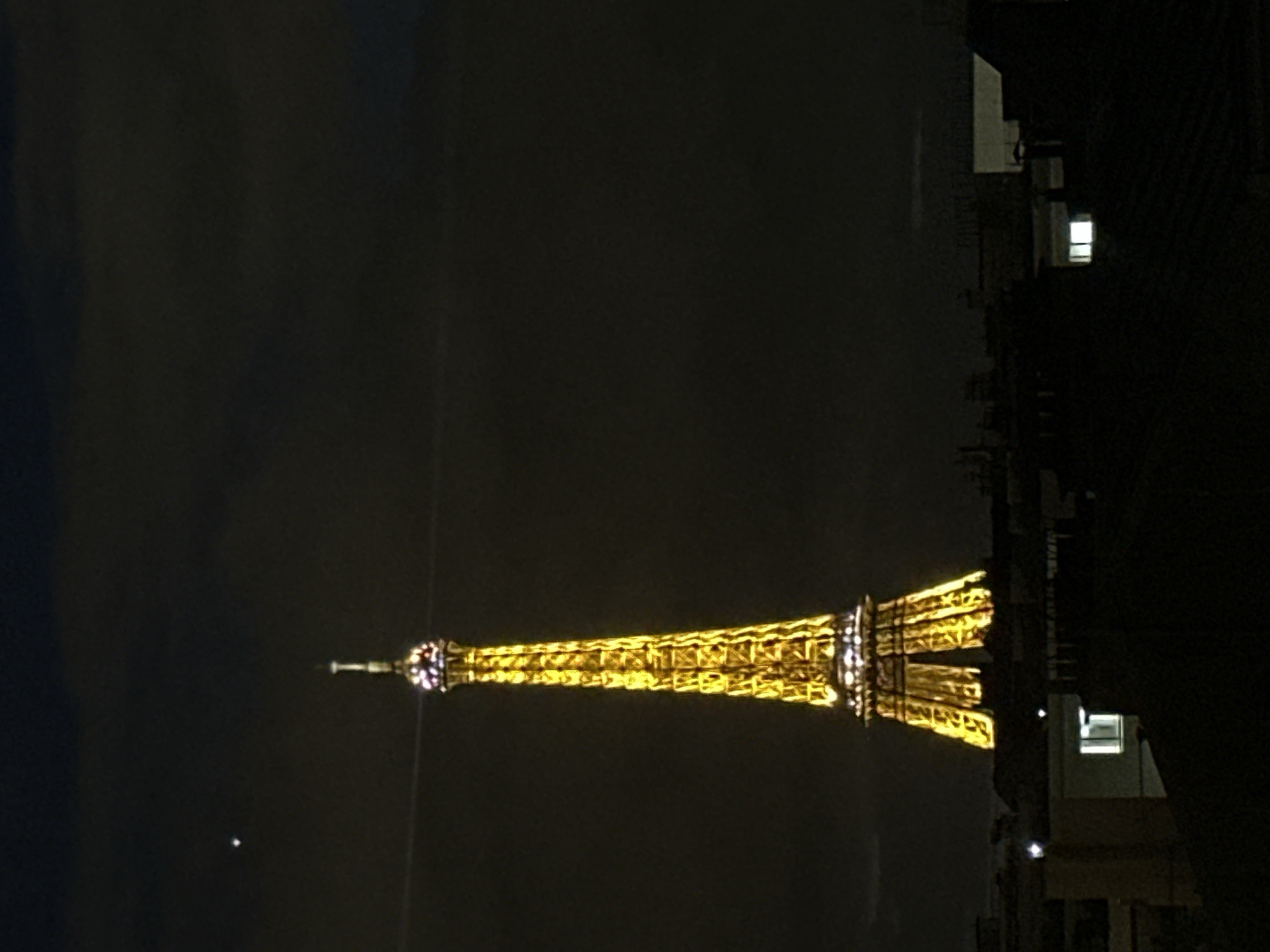 Eiffel Tower illumination captured across Paris nighttime skyline
