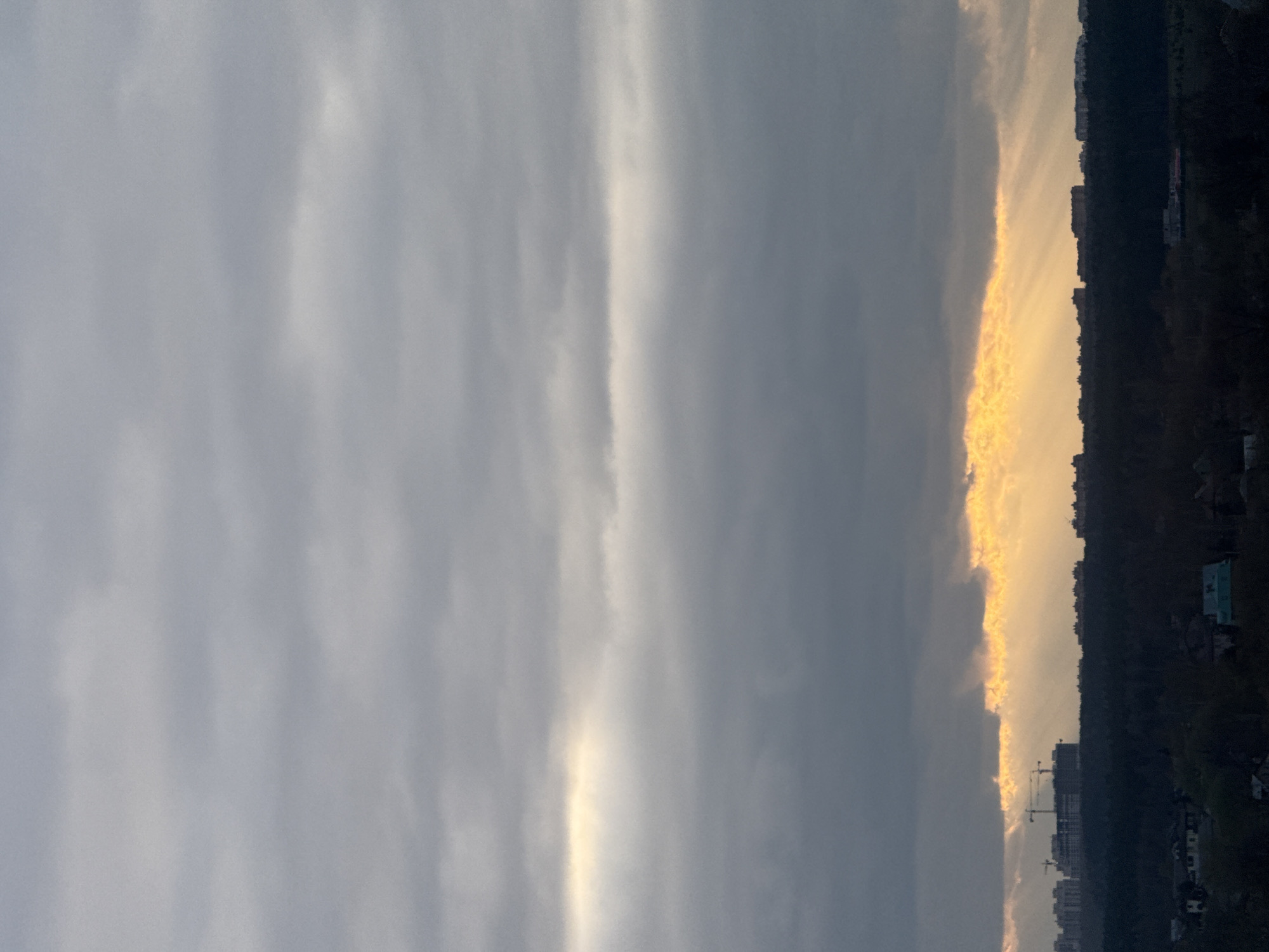 Sunset breaks through clouds over Mirny, Russia