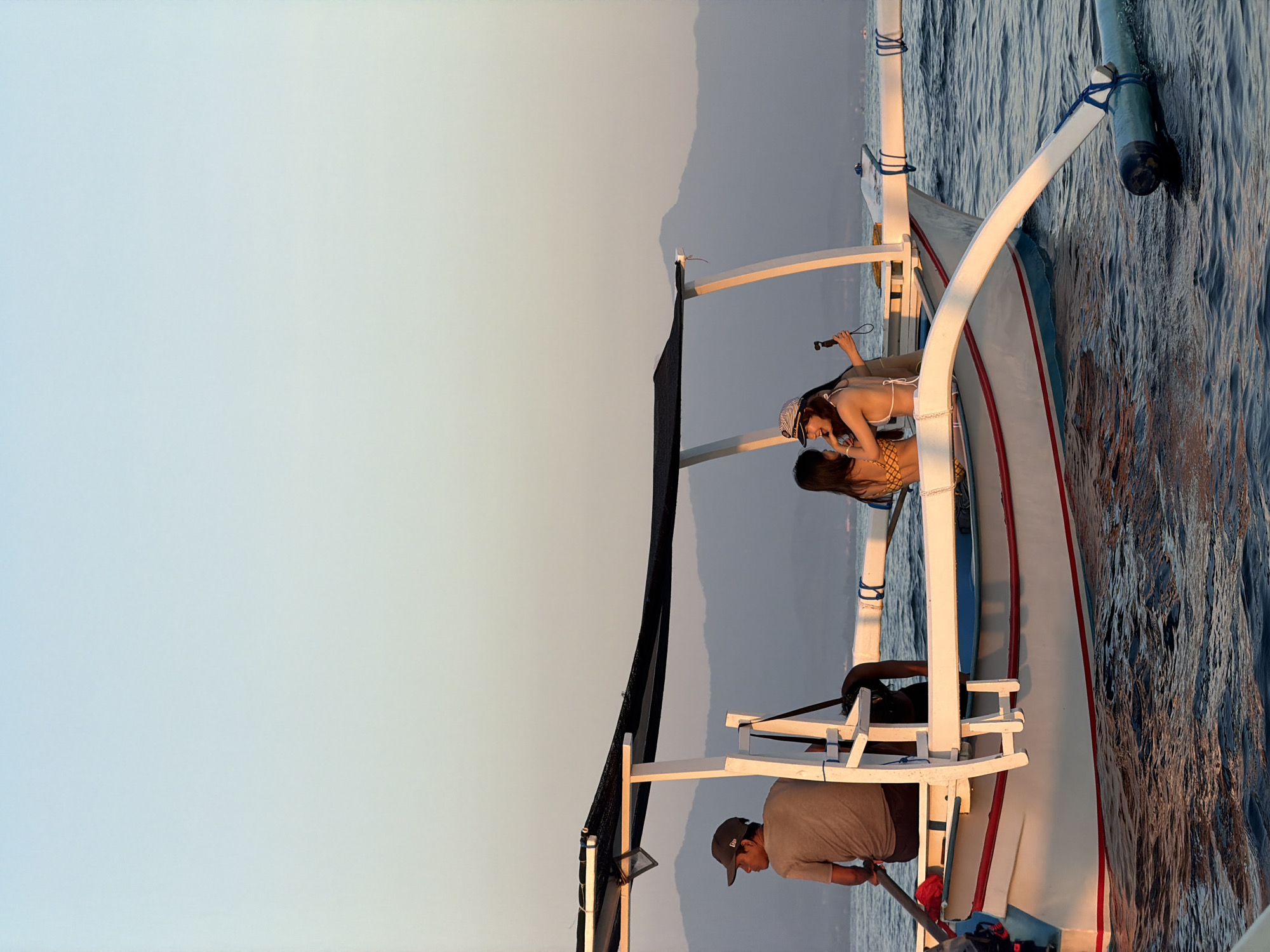 Sunset boat activity on Indonesian coastal waters