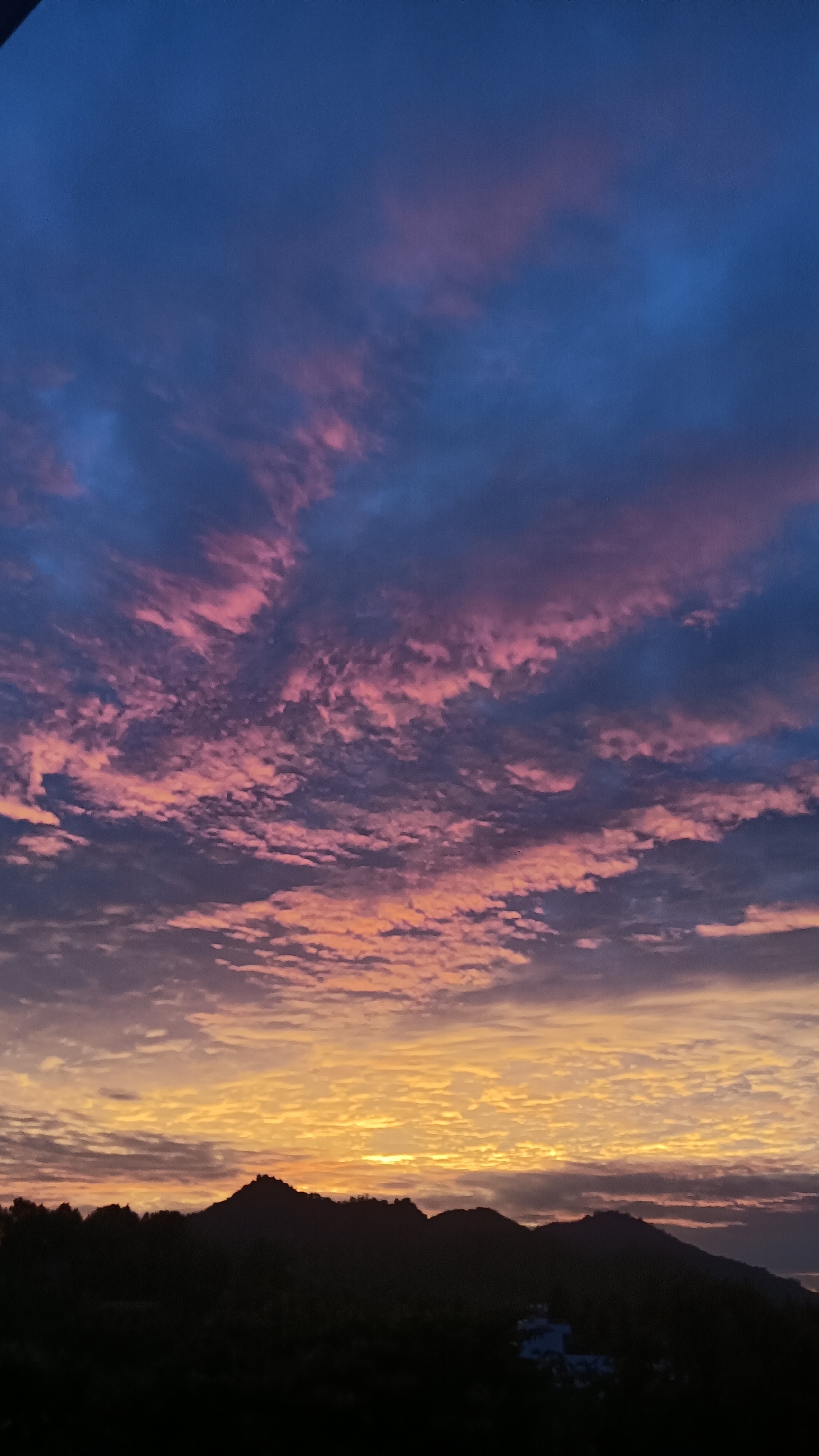 Rooftop sunset watch over Nha Trang's mountain skyline