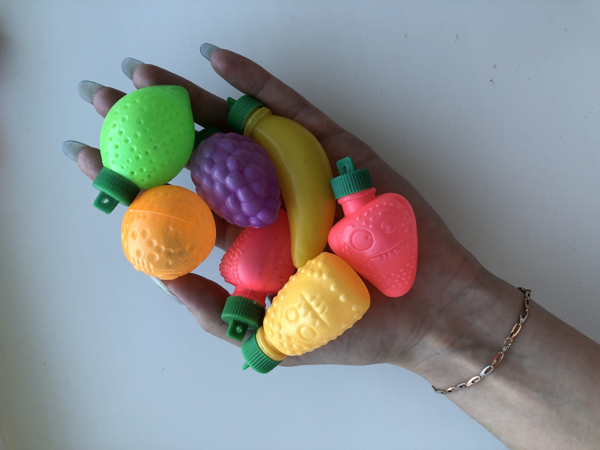 Person handles plastic toy fruits in Noviy, Russia