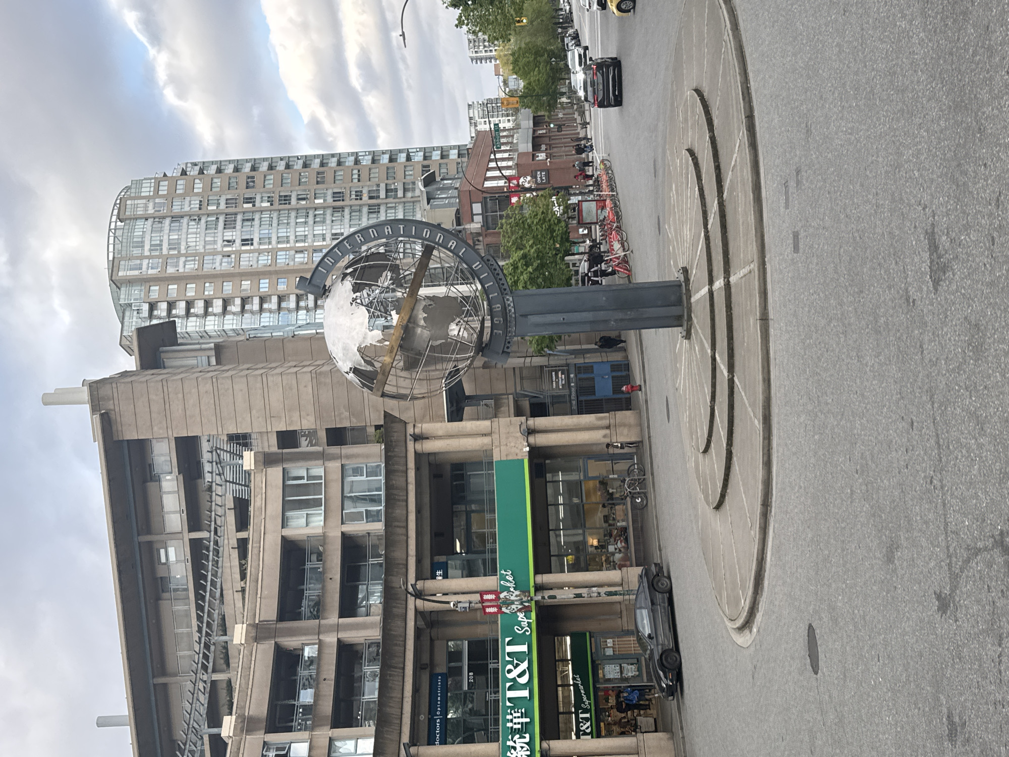 Globe sculpture observed on Vancouver street during cloudy day