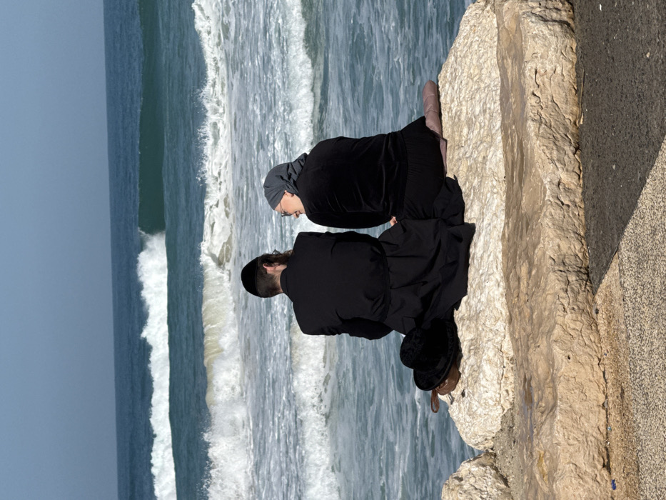 Surfers and beachgoers active along Tel Aviv Mediterranean coast
