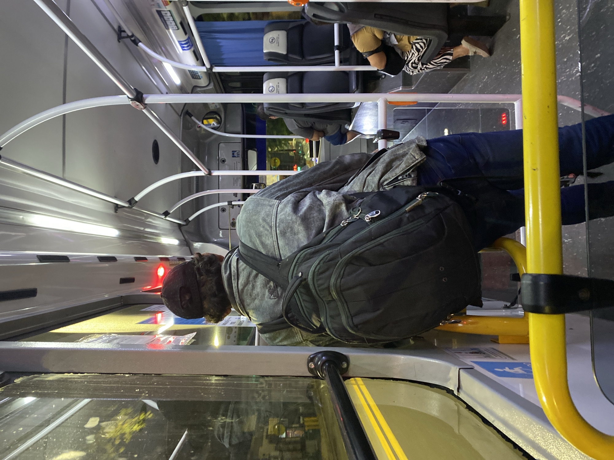 Morning commuter stands on Buenos Aires city bus