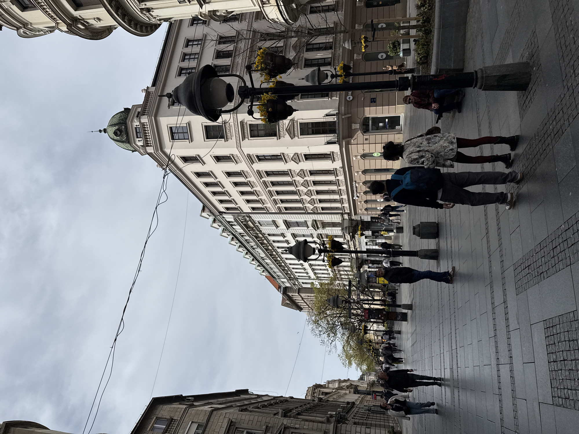 Street scene captured on Belgrade's Knez Mihailova featuring green-domed building