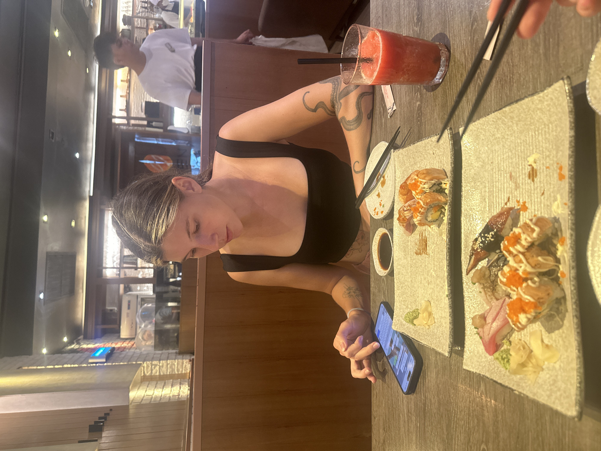 Woman enjoys sushi lunch at Thai restaurant