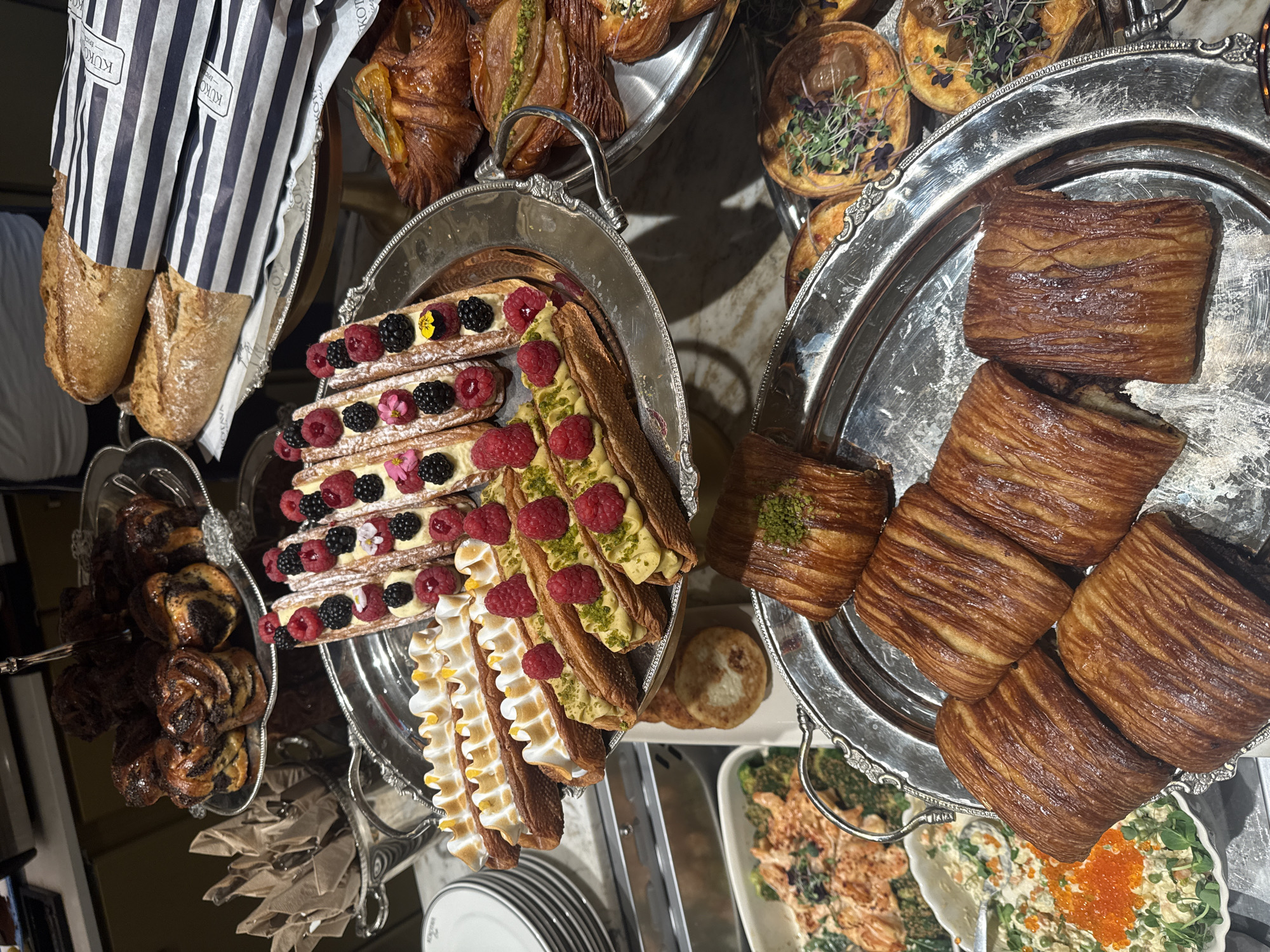 Diner documents pastry buffet and salad meal in Riga cafe
