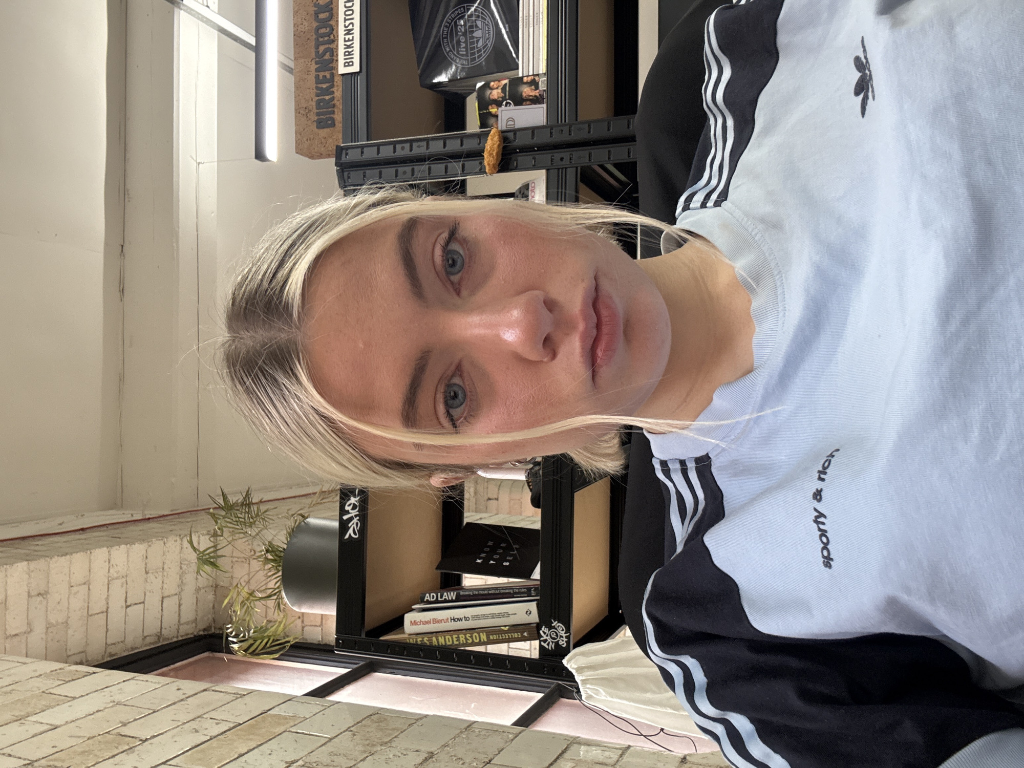 Woman in Adidas sportswear photographed indoors in Manchester