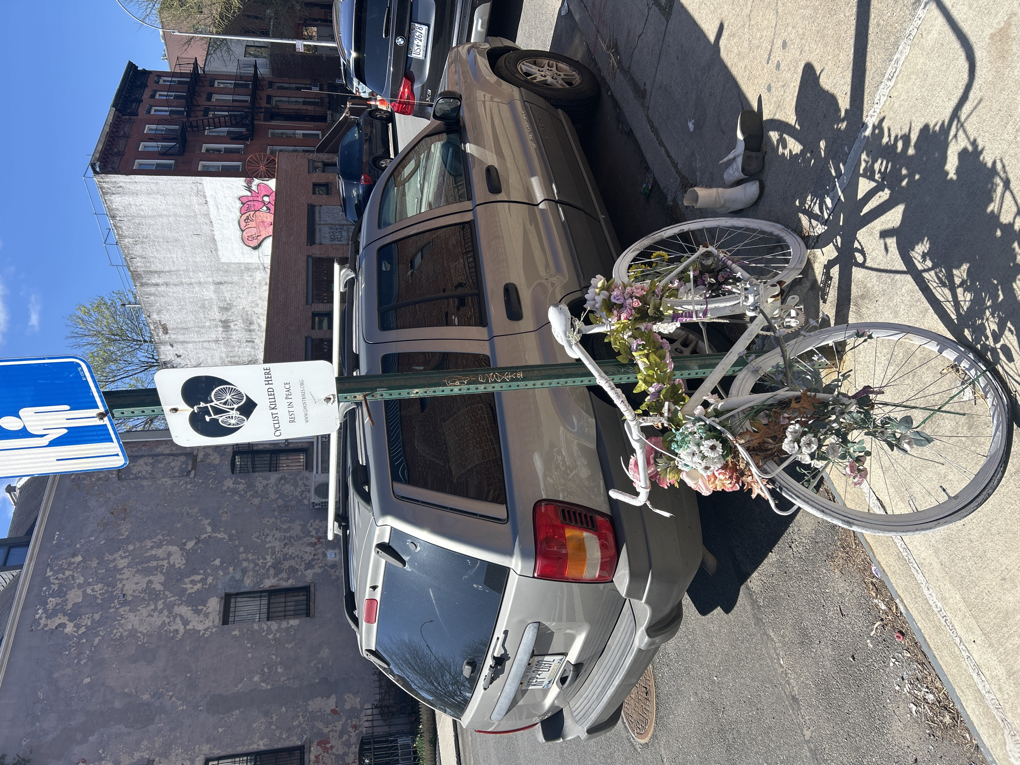 Ghost bike memorial with flowers spotted on NYC sidewalk
