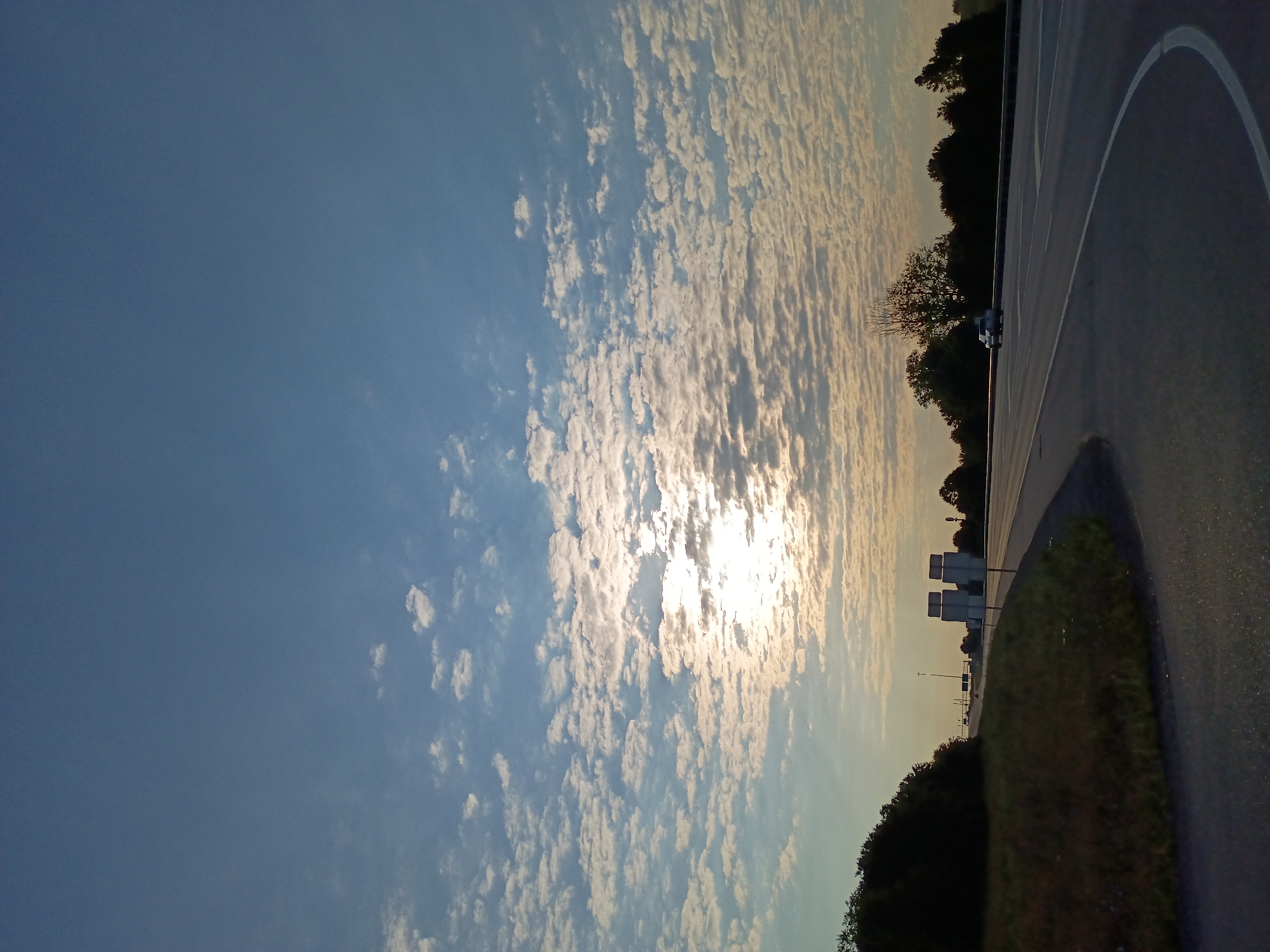 Open highway near Richmond, KY under a sun-streaked sky