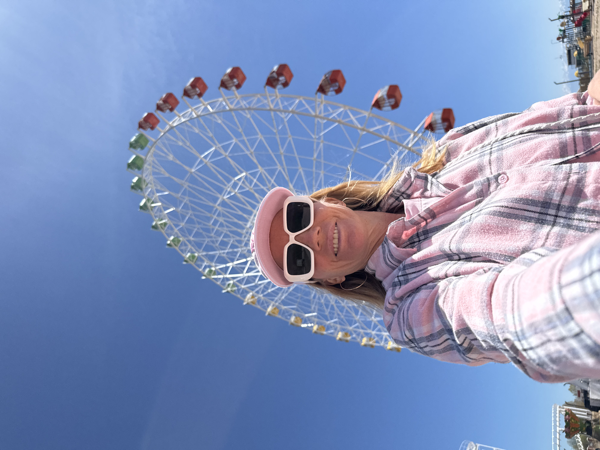 Tourist takes selfies at Ferris wheel pier in Kyrgyzstan