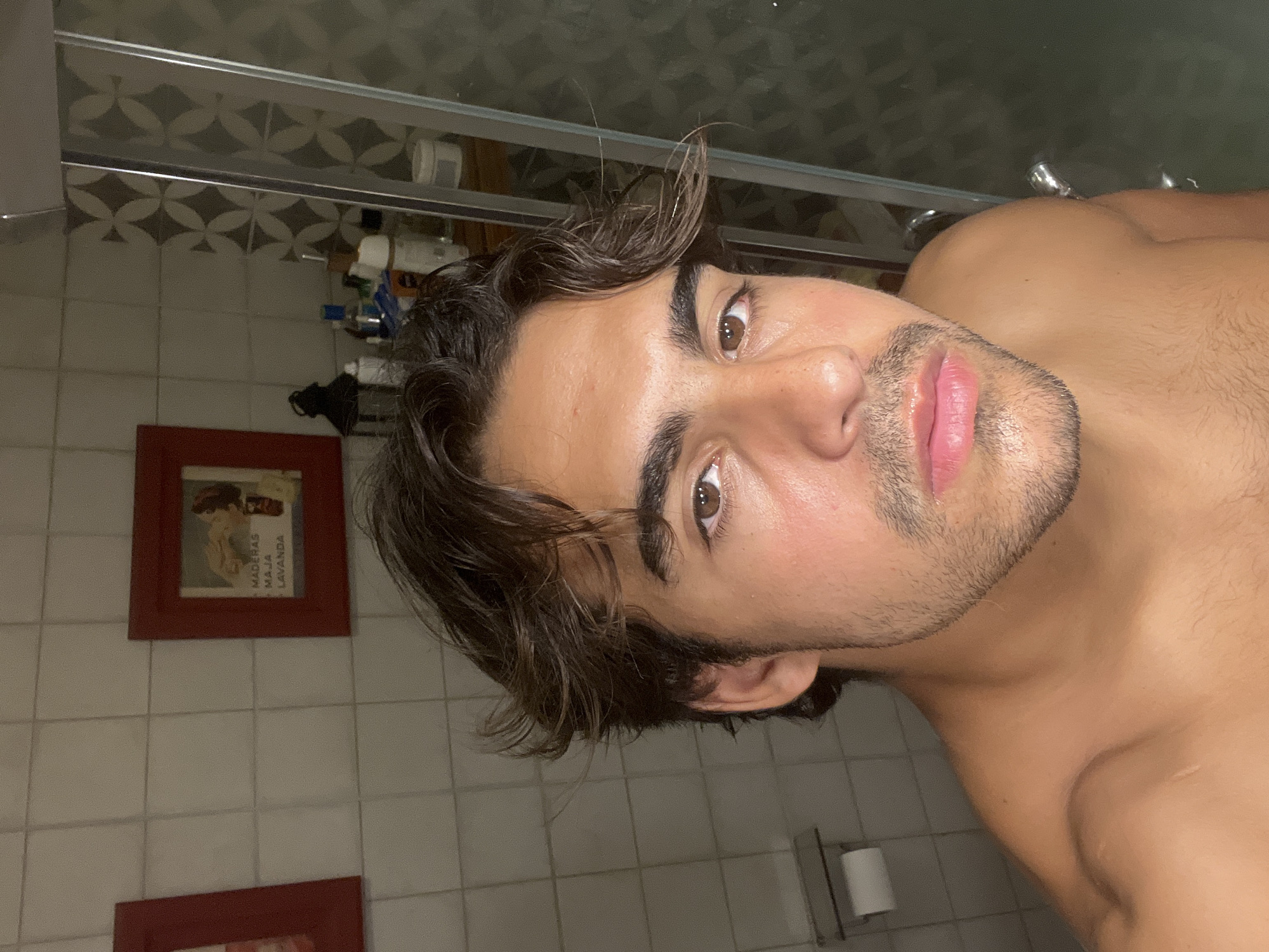 Man takes bathroom mirror selfies in Avellaneda, Argentina