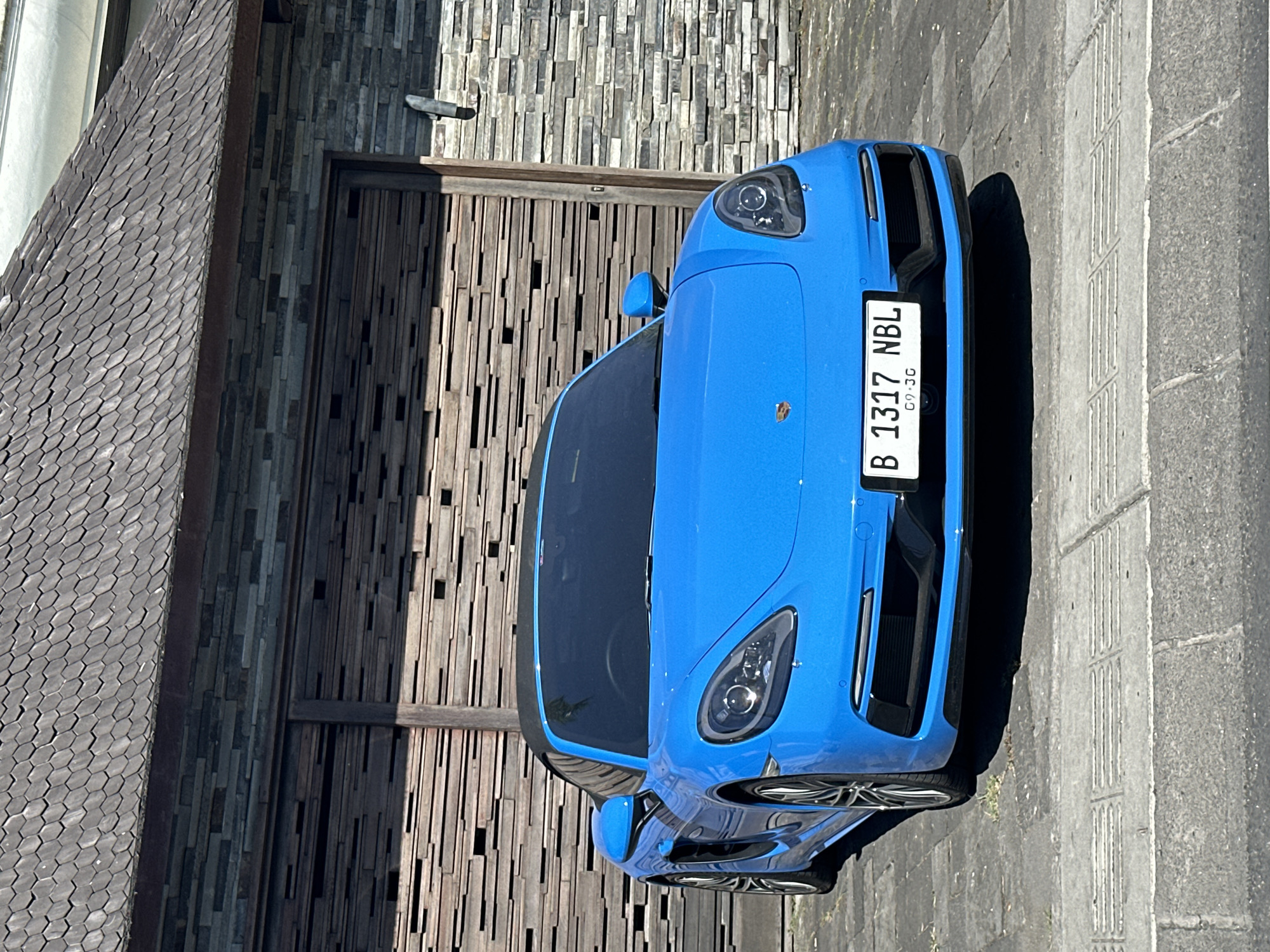 Blue Porsche, rice paddies, and a scooter in North Kuta