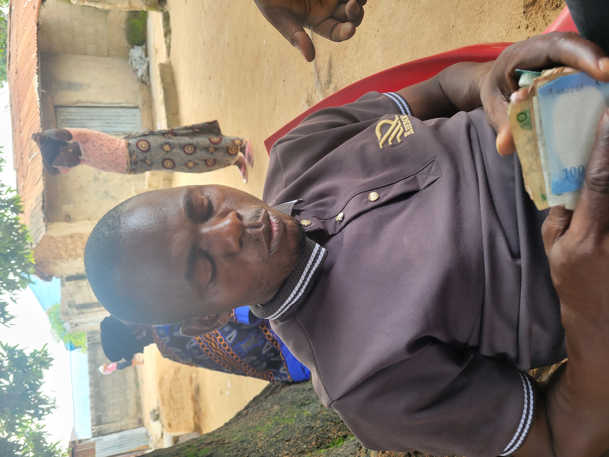 Casual outdoor gathering under a tree in Madalla, Nigeria