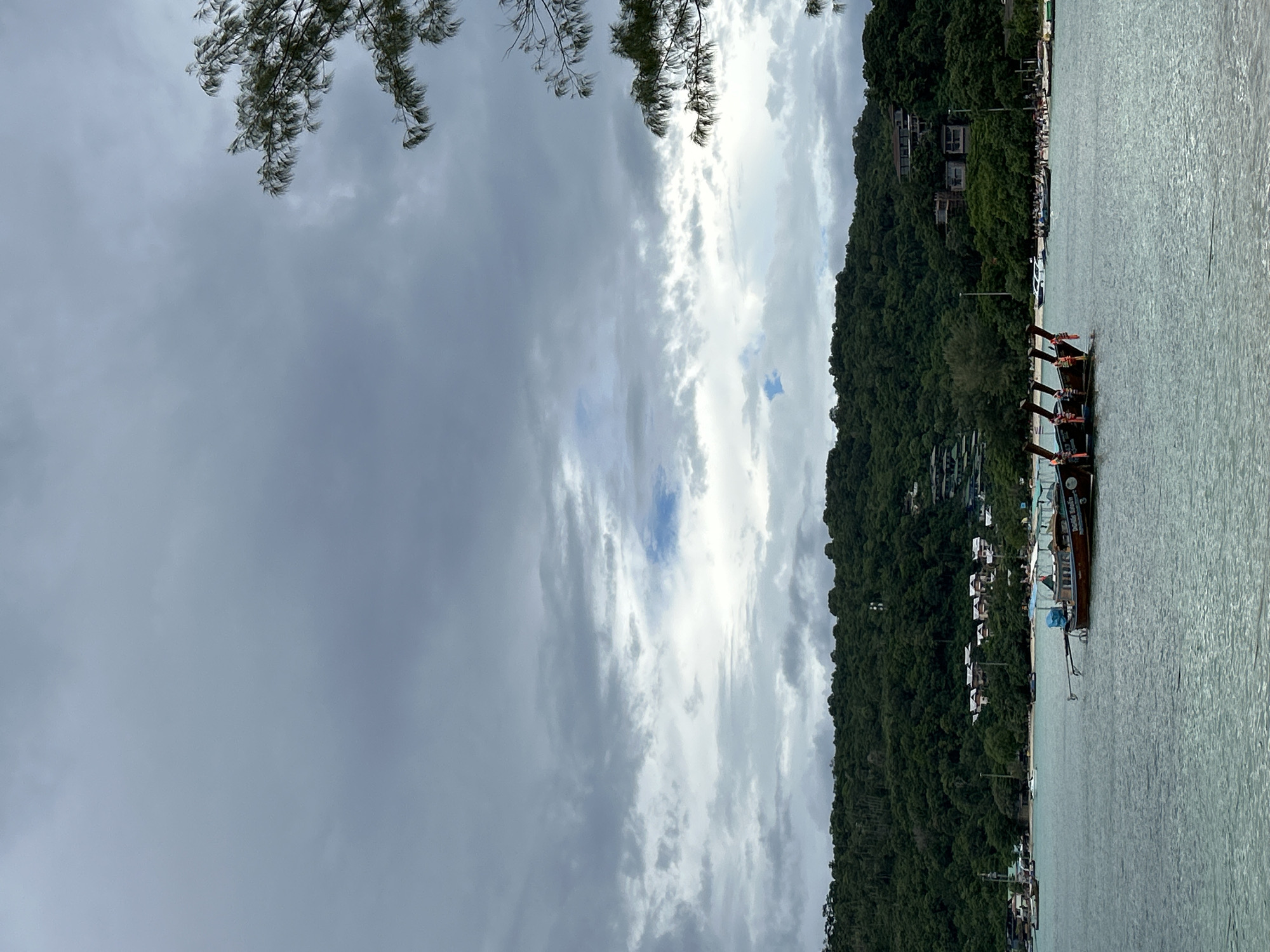 Ao Nang coastline: boats, karst cliffs, and beach at dawn