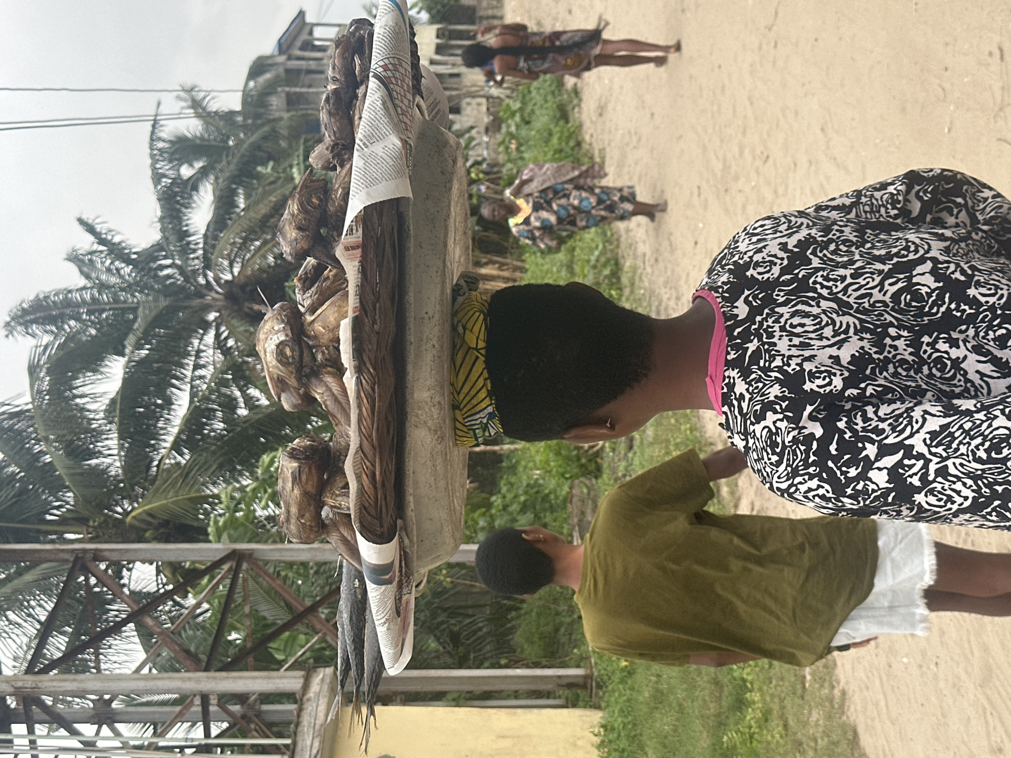 Everyday life in Badagry's sandy streets on a cloudy afternoon