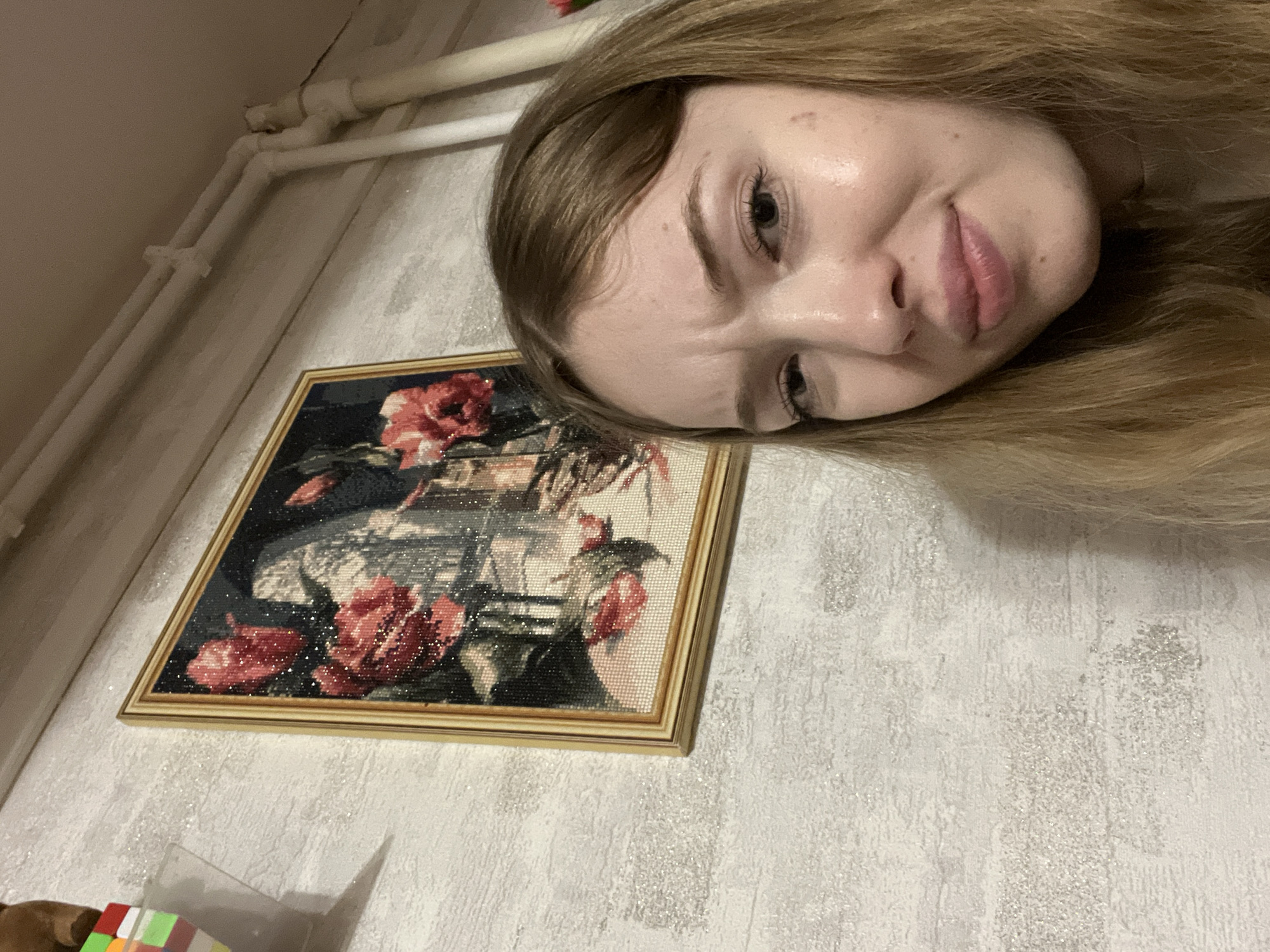 Woman displays embroidery work in Сосново, Russia