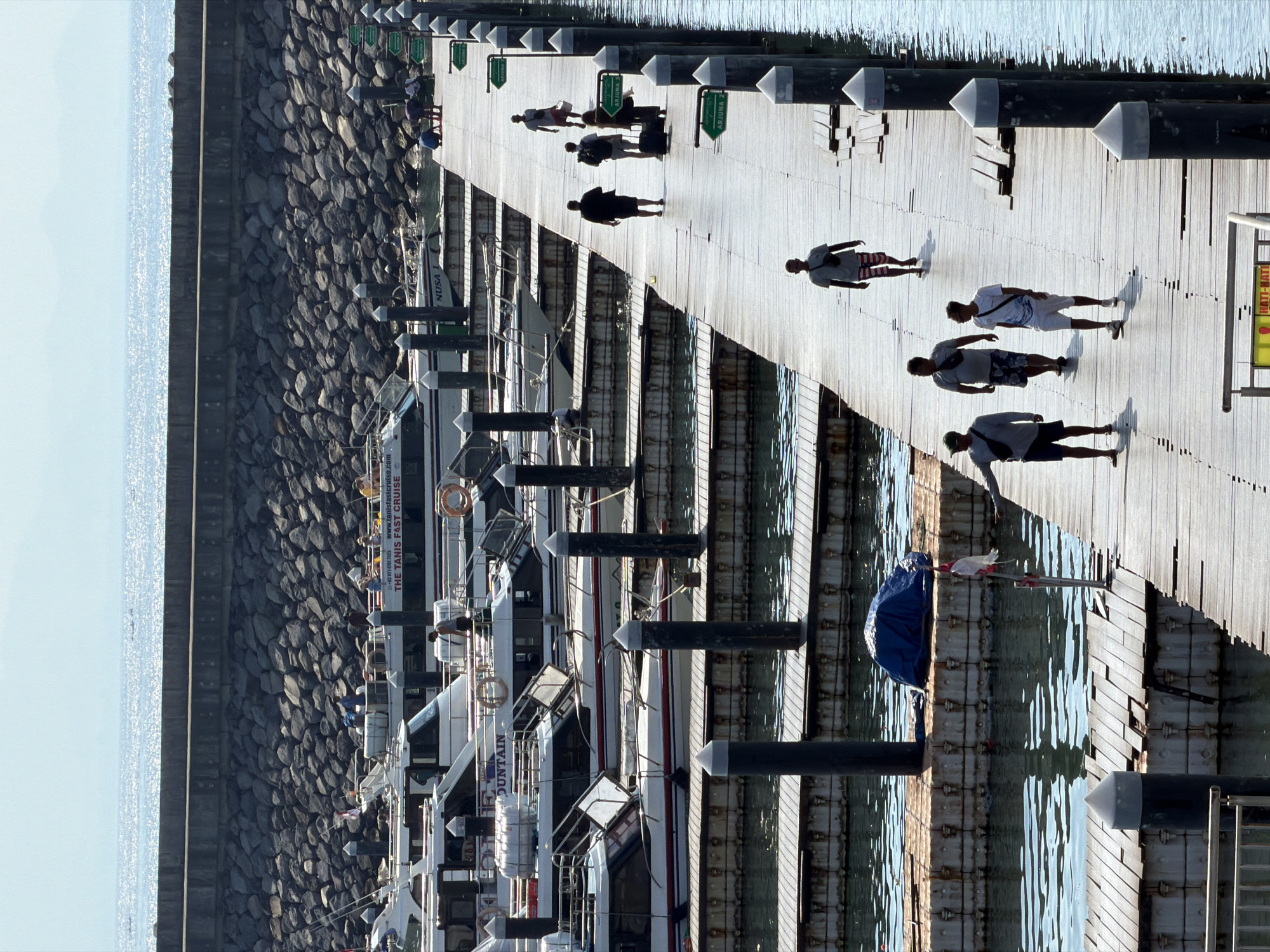 Morning scenes documented across Denpasar: pier, market, cafe, statue