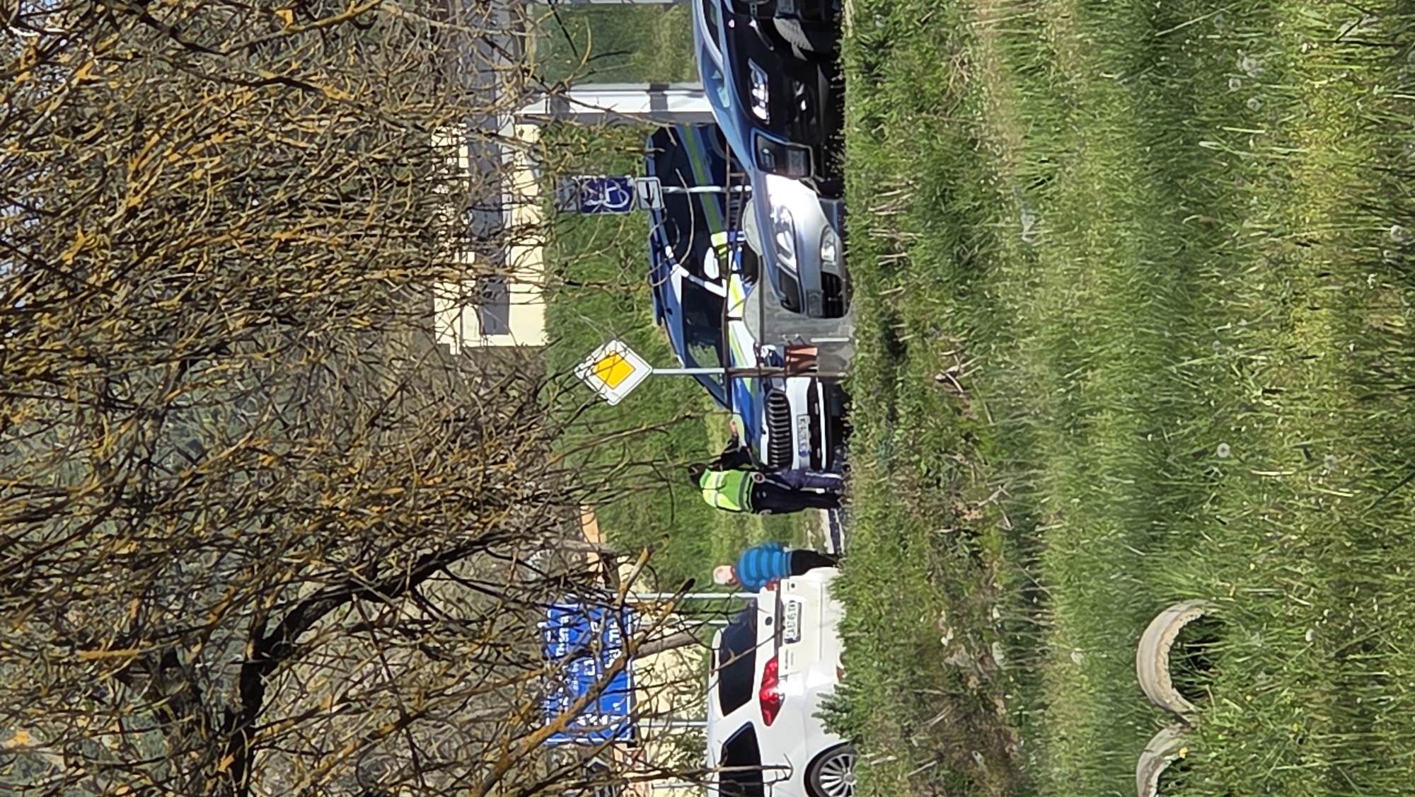 Safety worker spotted near parked vehicles on city roadside