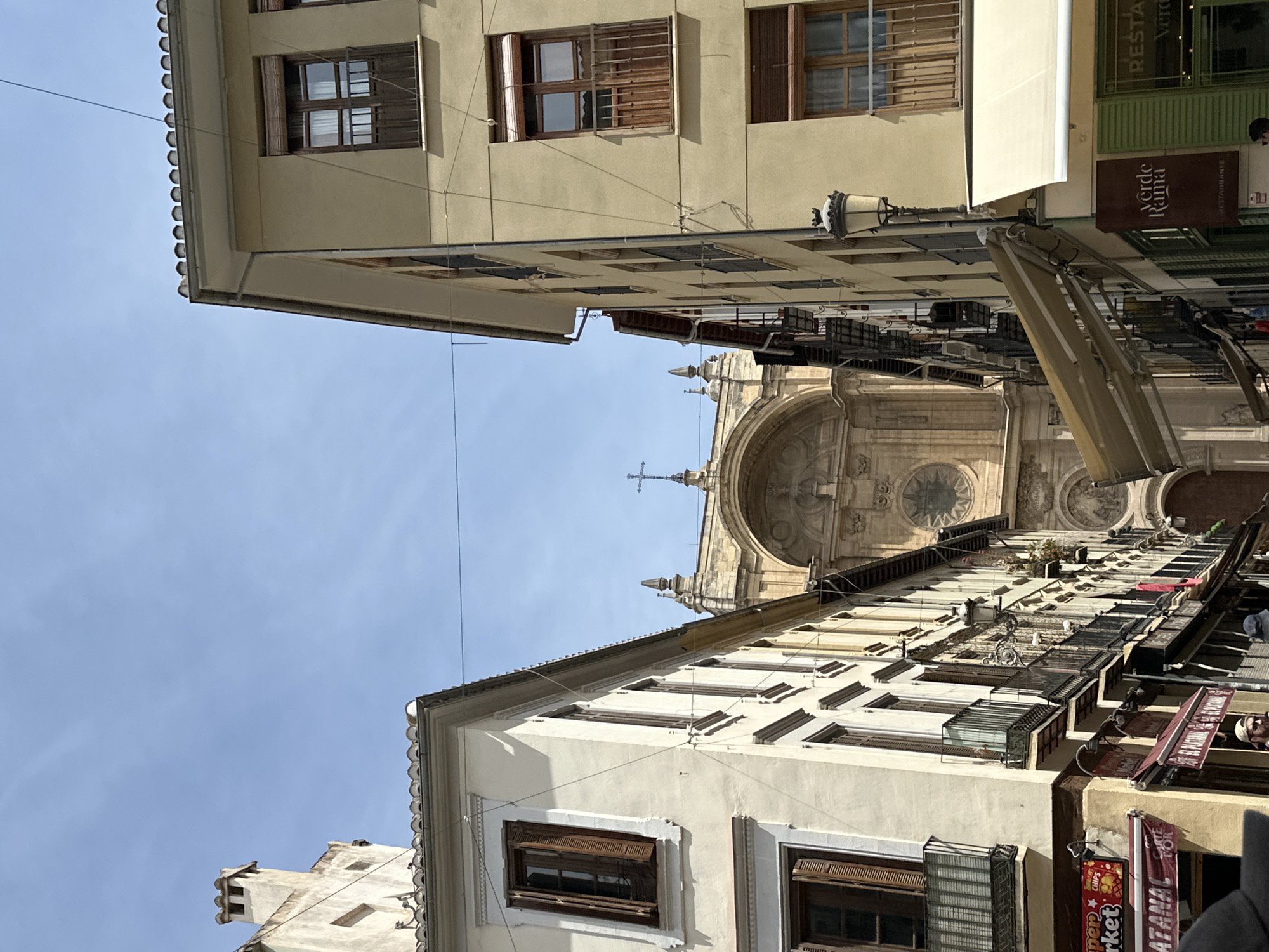 Tourist documents Granada cathedral district during midday stroll