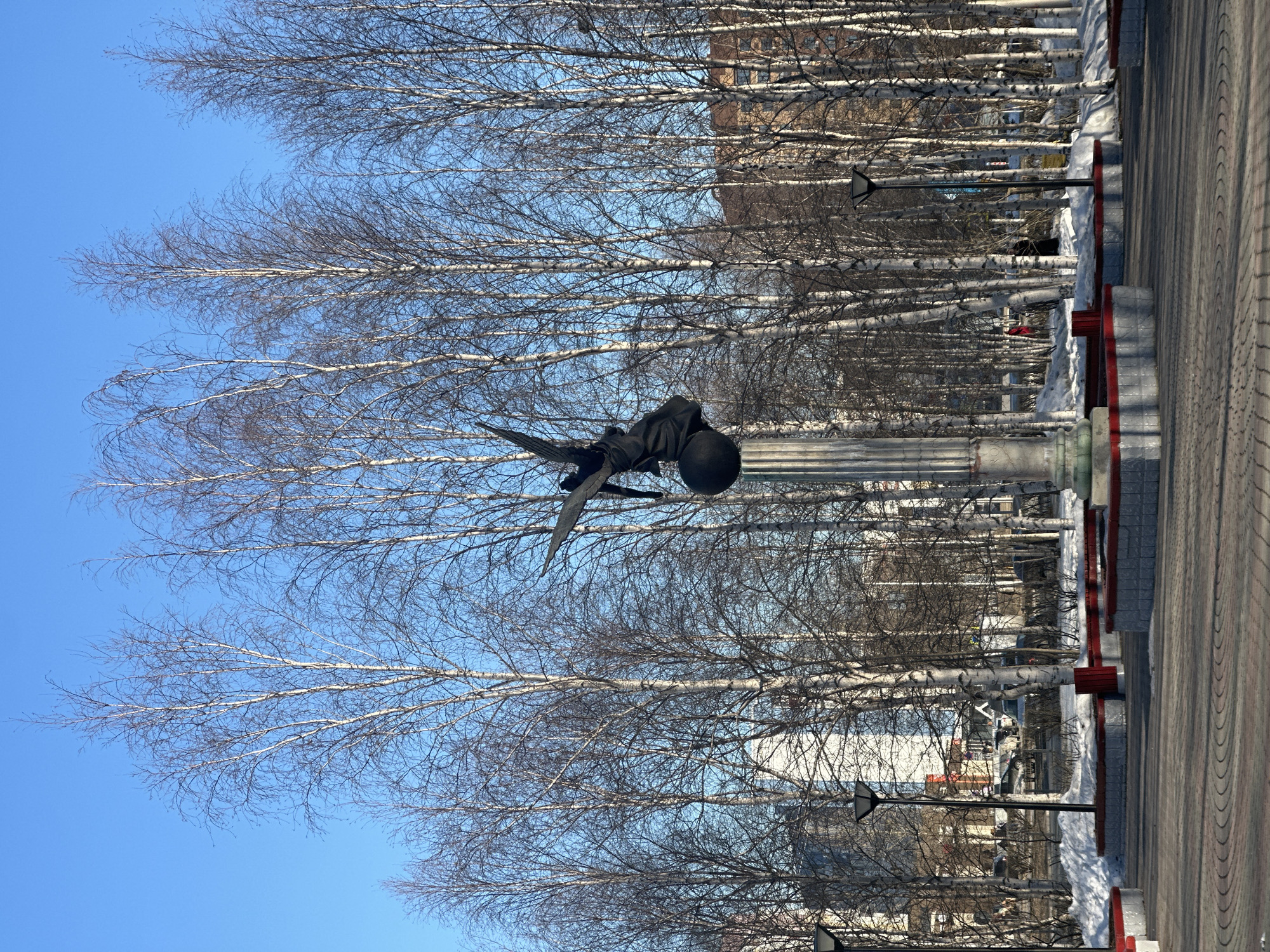 Casual moments captured near winged monument in Surgut, Russia