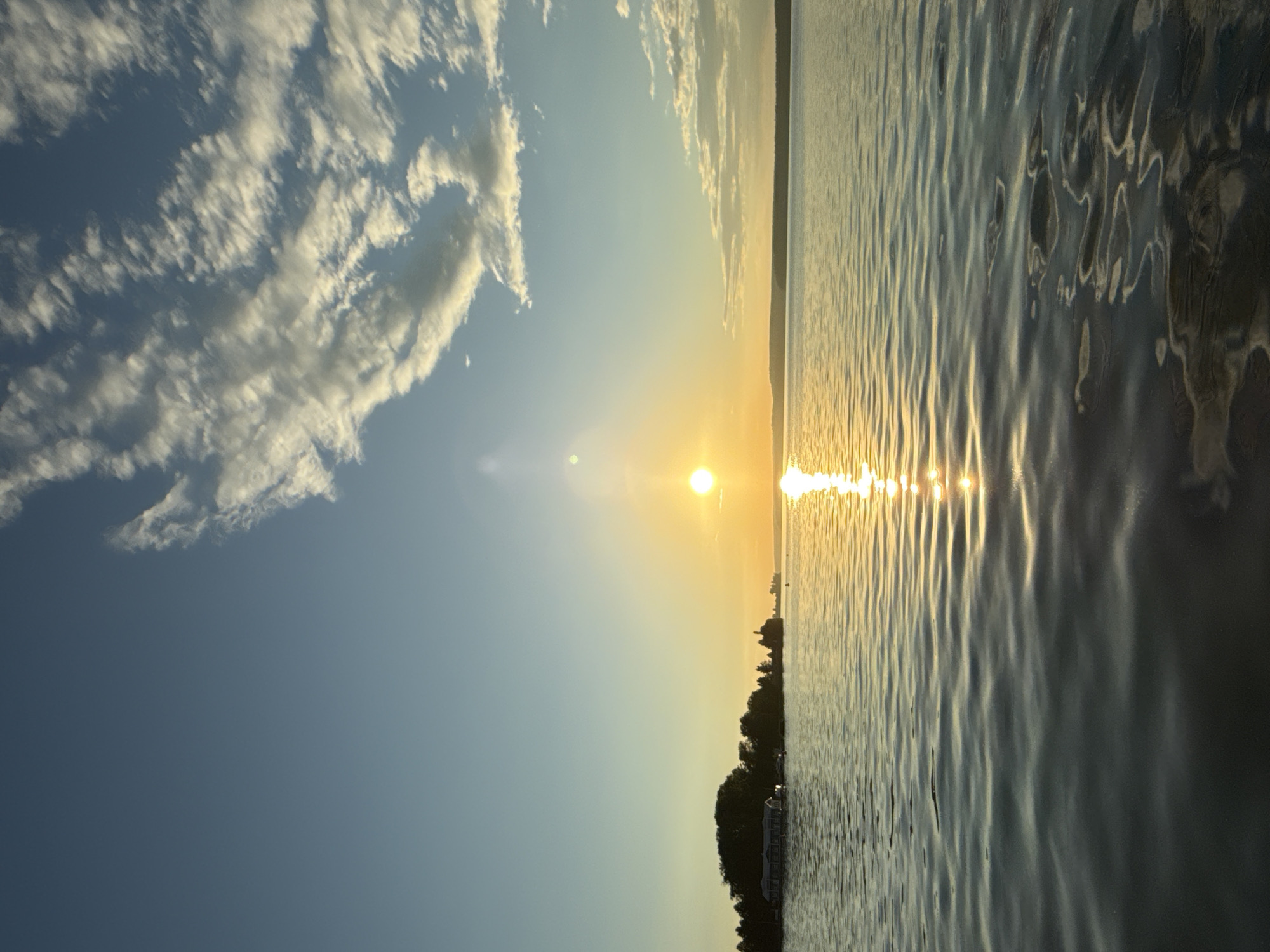 Votkinsk at golden hour: water, churches, and city skyline