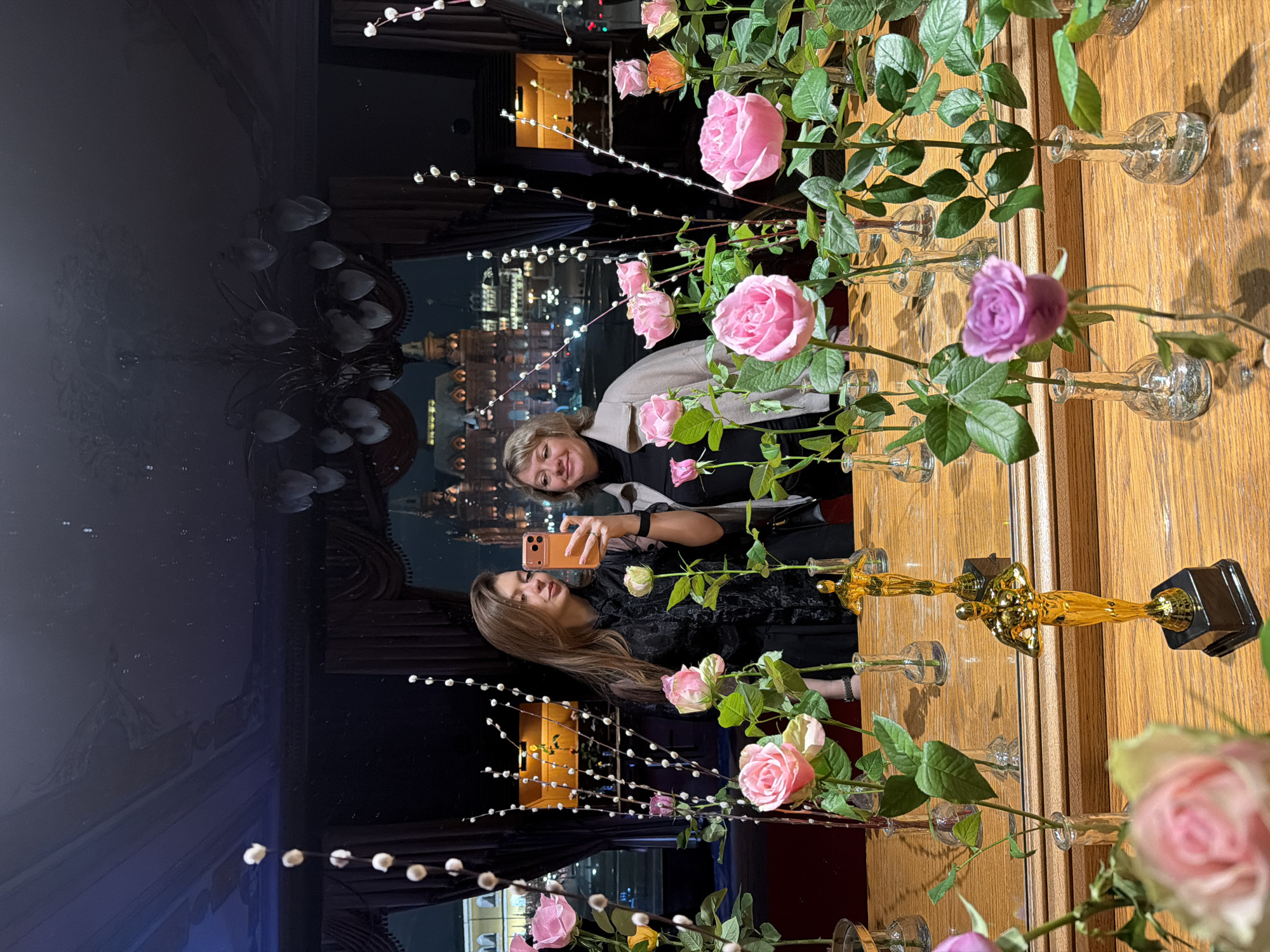 Women captured taking selfies in ornate interior spaces